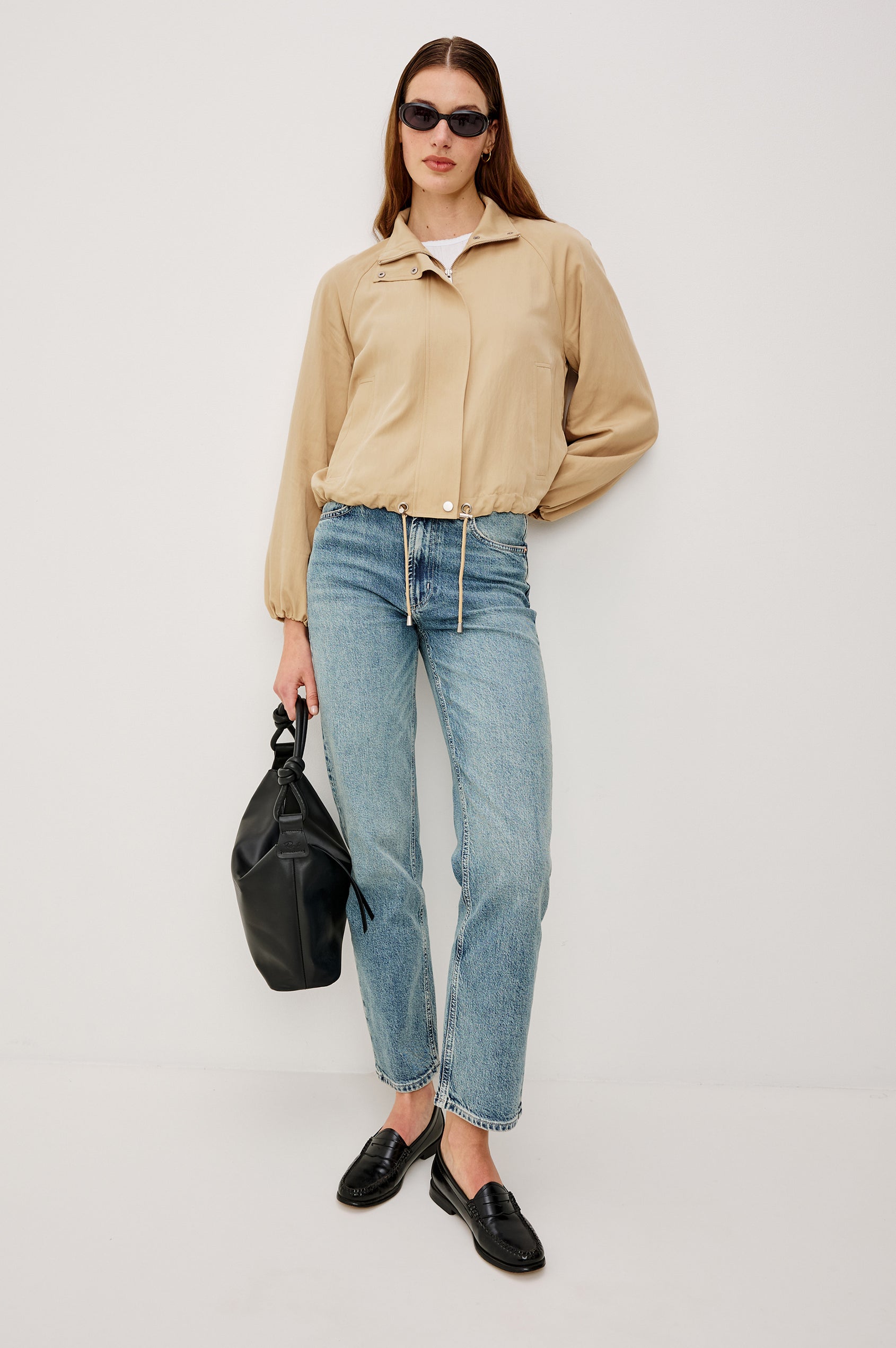 Blake Oversized Cropped Jacket With High Funnel Neck Double-Button Closures Long Drop Shoulder Sleeves With Elastic Cuffs Side Pockets and Drawstring Hem in Almond Colorway - Full Body Front View Featured on Model