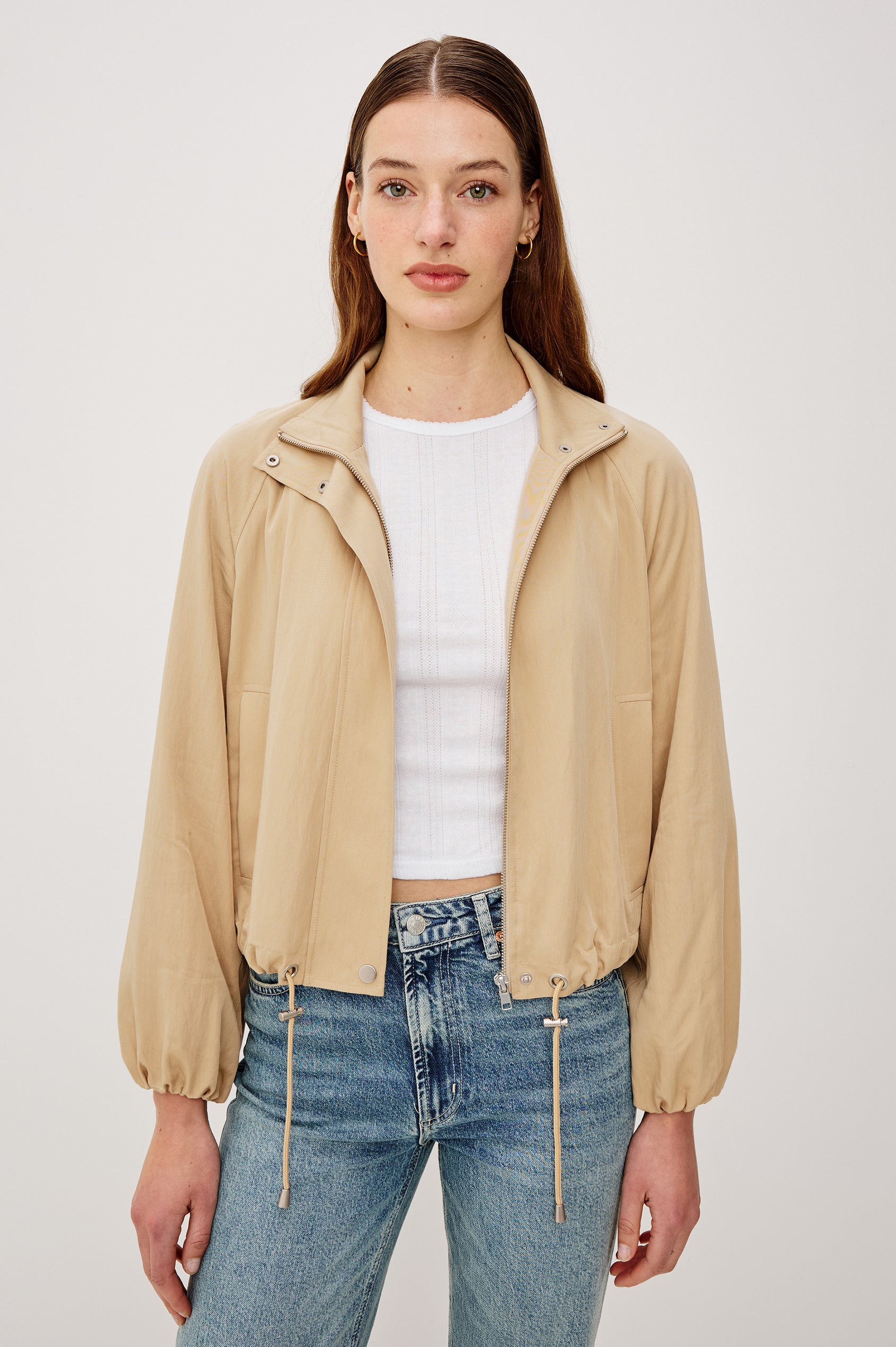 Black Jacket With Oversized Relaxed Fit High Funnel Neck Dropped Shoulders Long Sleeves Center-Front Ties Side-Seam Zipper in Almond Colorway - Upper Body Front View Featured on Model
