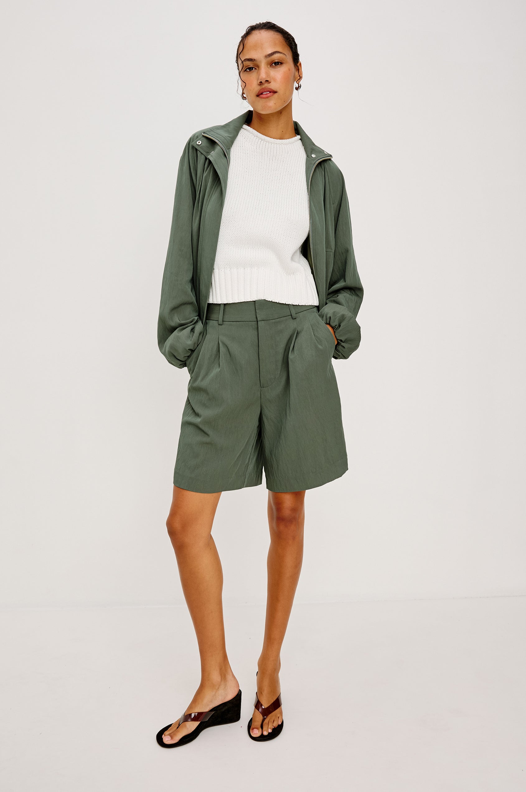 Black Jacket With Oversized Relaxed Fit, High Funnel Neck, Dropped Shoulders, Long Sleeves, Center-Front Ties, Side-Seam Zipper in Ivy Colorway - Full Body Front View Featured on Model