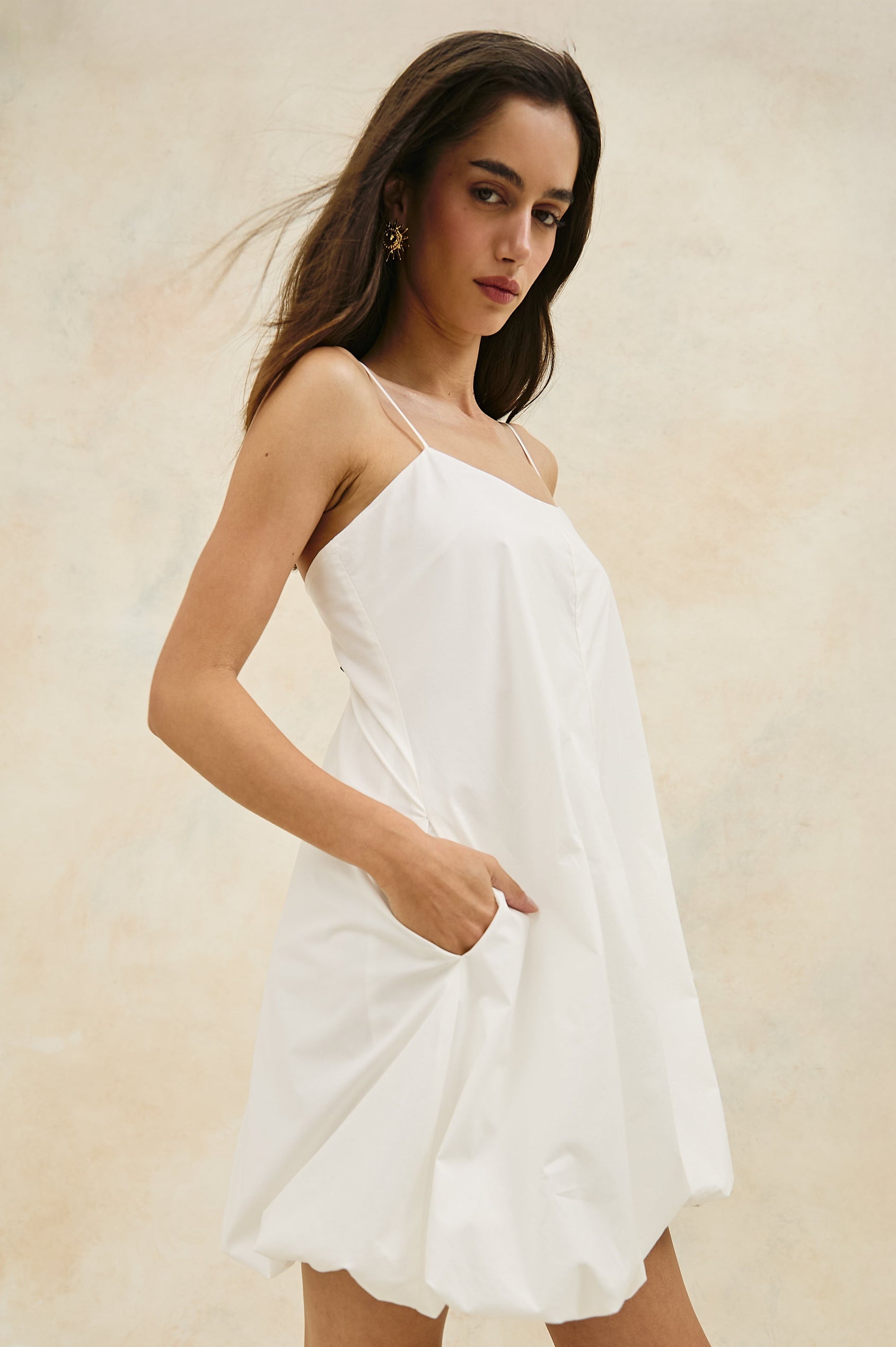 Bianca Mini Tank Dress with Spaghetti Straps, Side Pockets and a Bubble Hem in White Colorway. Side View Shown on Model.