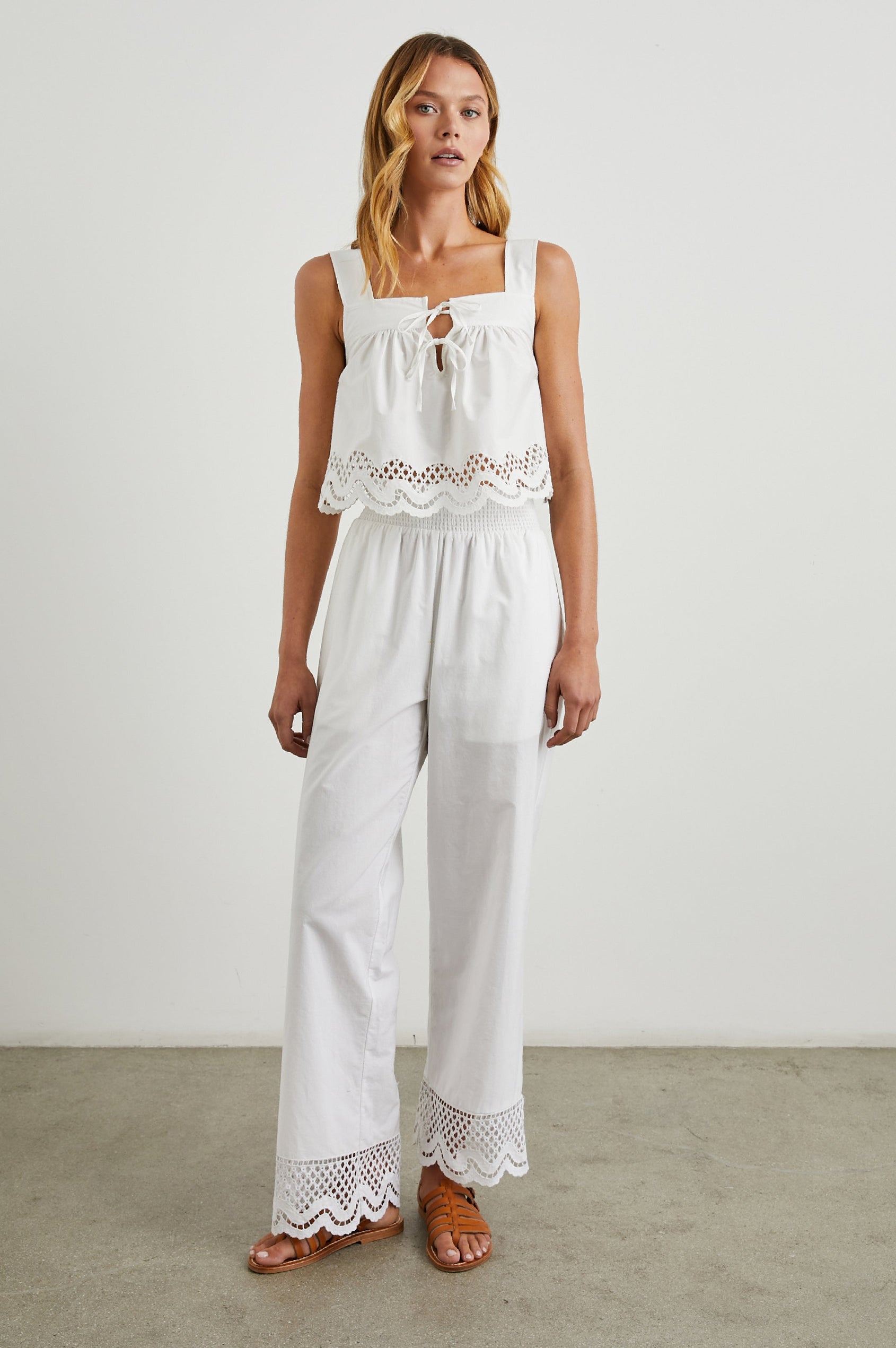 Blythe Crop Tank Top with a Deep Neck with Ties and a Scalloped Hem with Eyelet Embroidery  in White Colorway - Front Full Body View Featured on Model 