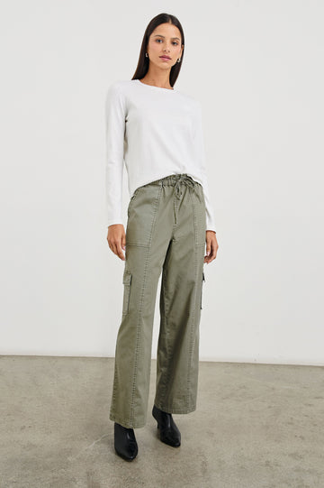 Bodie Pants with a Drawstring Waist, Front and Back Center Vertical Leg Seams, Two Front Pockets, Two Flap Side Pockets and Two Back Welt Pockets in Dark Olive Colorway - Front Full Body View Featured on Model  