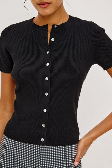 Bonnie Fitted Top in Ribbed Cotton With Crew Neckline Short Sleeves and Front Buttons in Black Colorway - Upper Body Front Close Up View Featured on Model