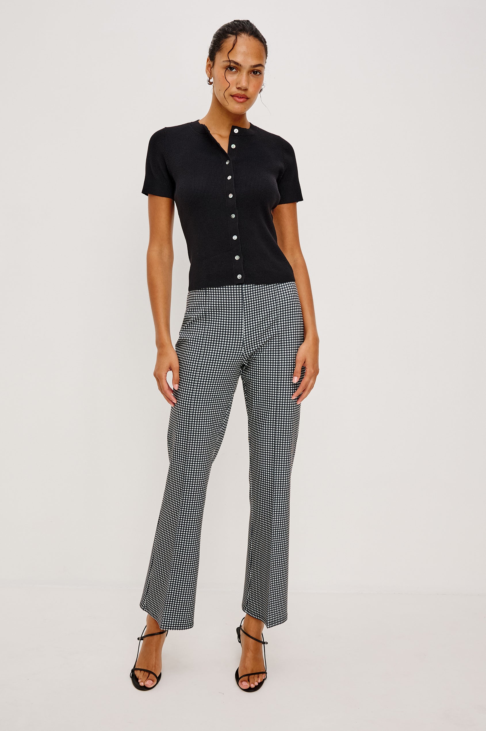 Bonnie Fitted Top in Ribbed Cotton With Crew Neckline Short Sleeves and Front Buttons in Black Colorway - Full Body Front View Featured on Model