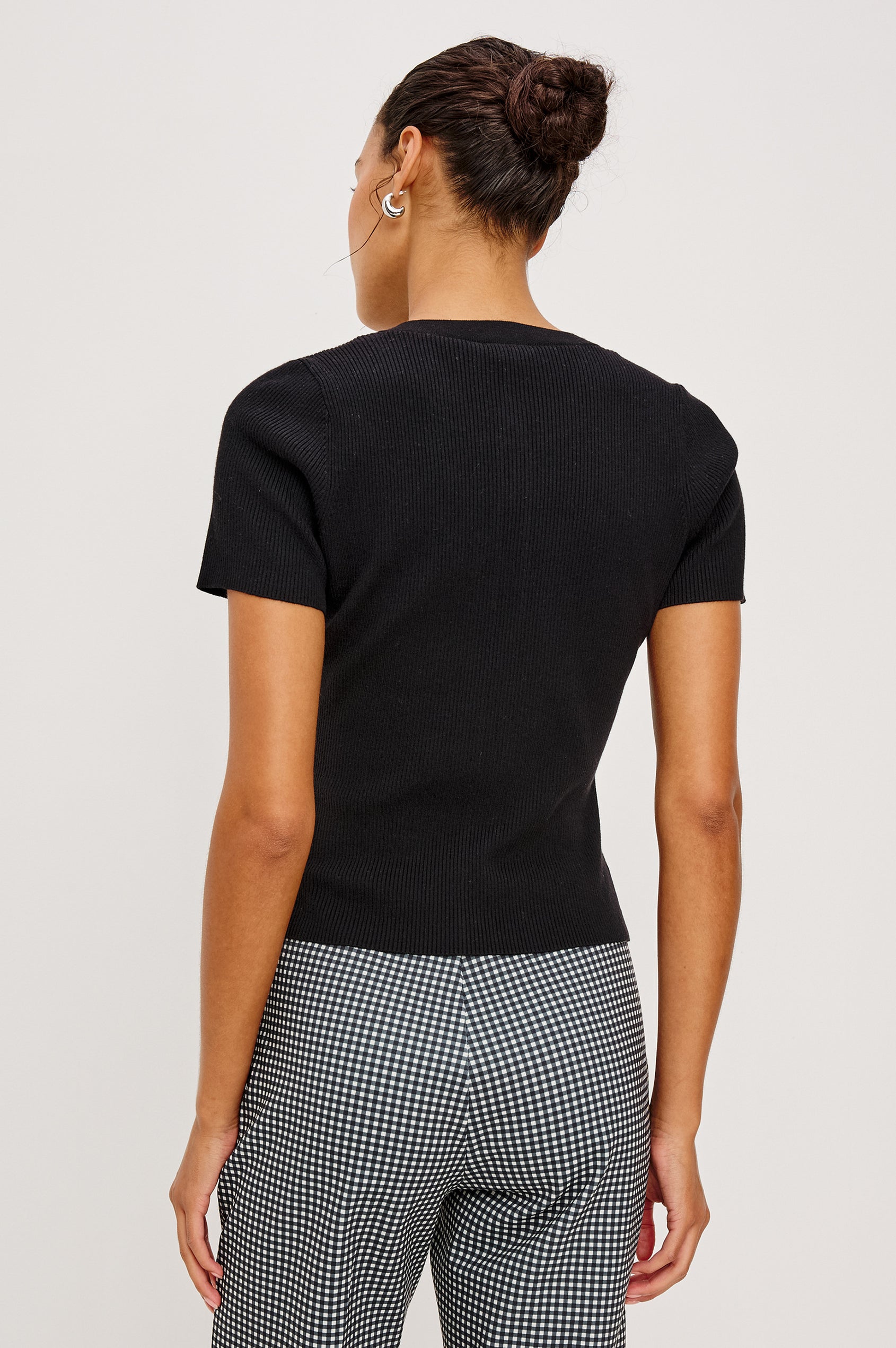 Bonnie Fitted Top in Ribbed Cotton With Crew Neckline Short Sleeves and Front Buttons in Black Colorway - Upper Body Front View Featured on Model