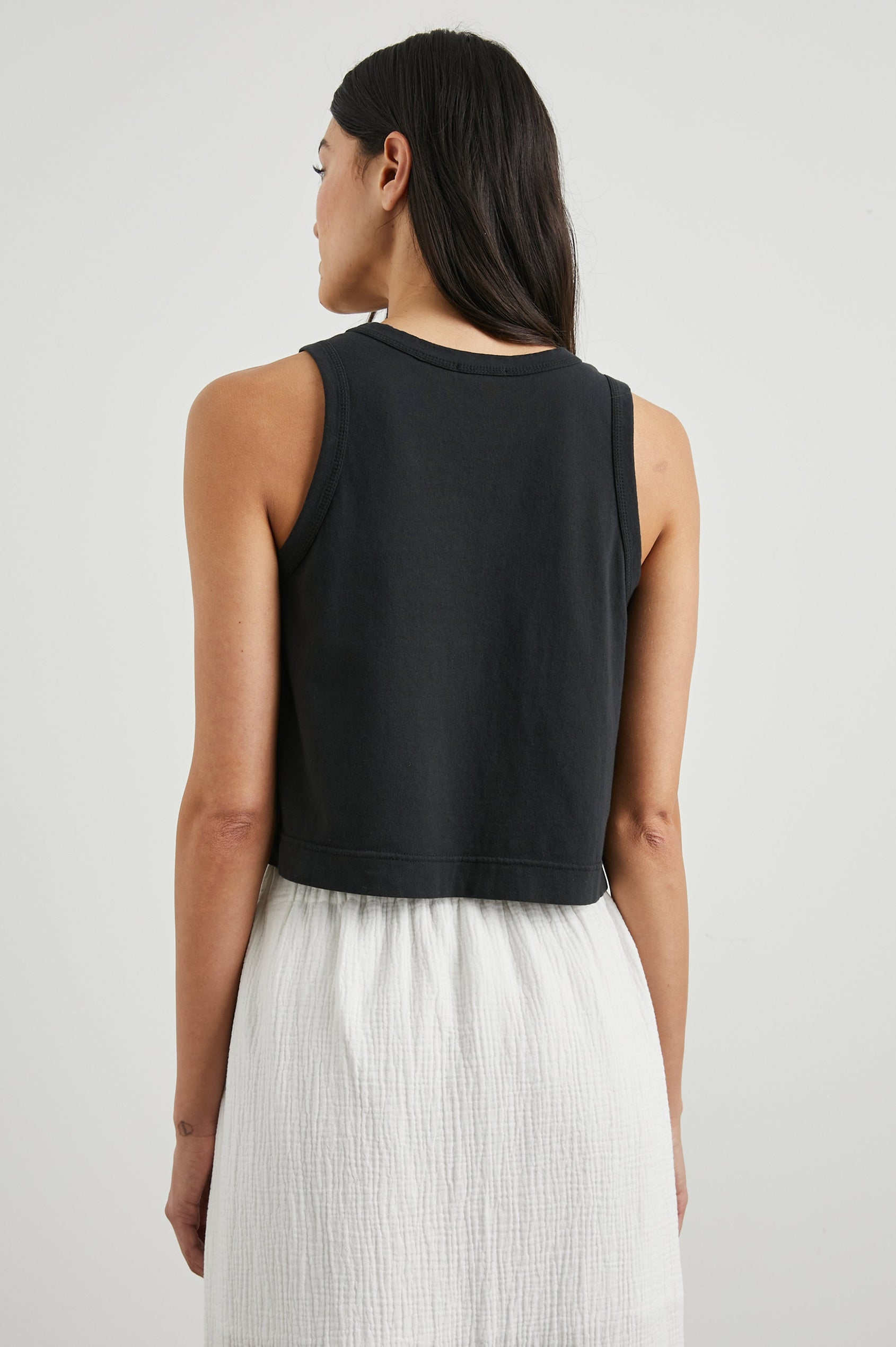 The Boxy Cropped Tank with a Crew Neck in Black Colorway - Back View Featured on Model