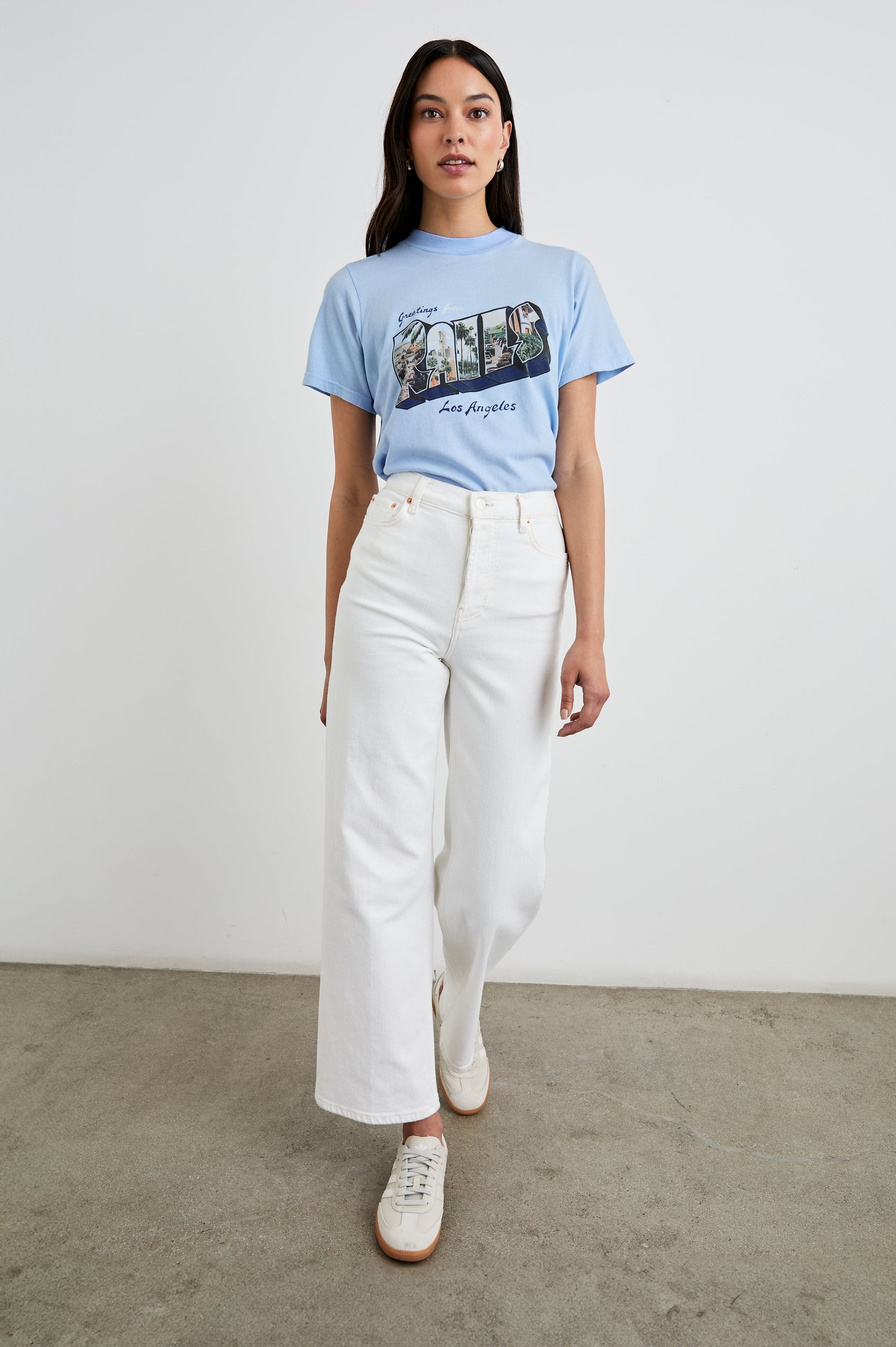 Boyfriend T-Shirt with a Crew Neck, photographs of Los Angeles and the text, Greetings From Rails Los Angeles in Rails Los Angeles Blue Colorway, with text in Blue and White - Front Tucked Full Body View Featured on Model