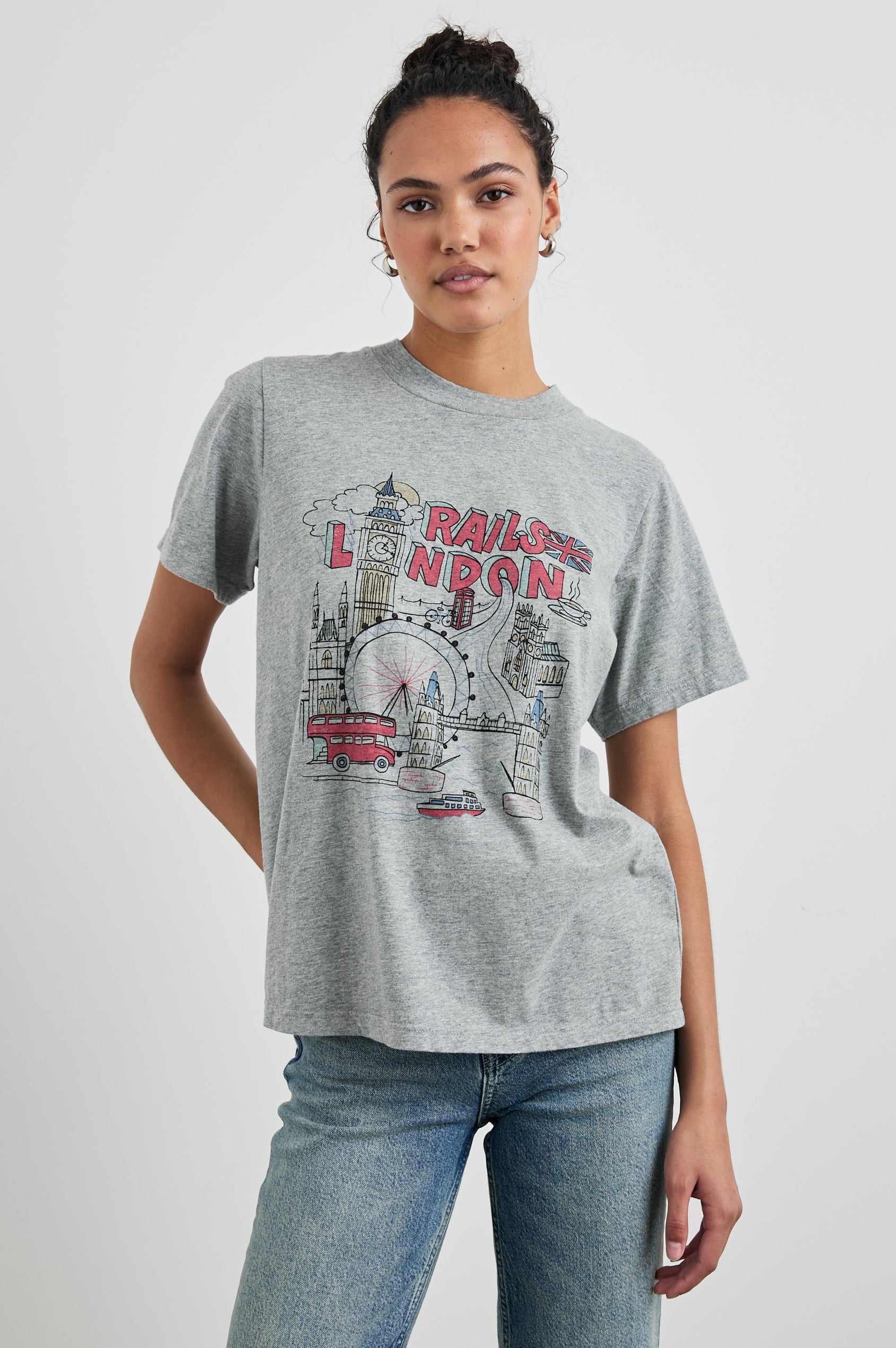Boyfriend T-Shirt with a Crew Neck, images of London and the text, Rails London in Rails London Colorway, with text and image in pink, yellow and blue on a Grey shirt - Front View Featured on Model