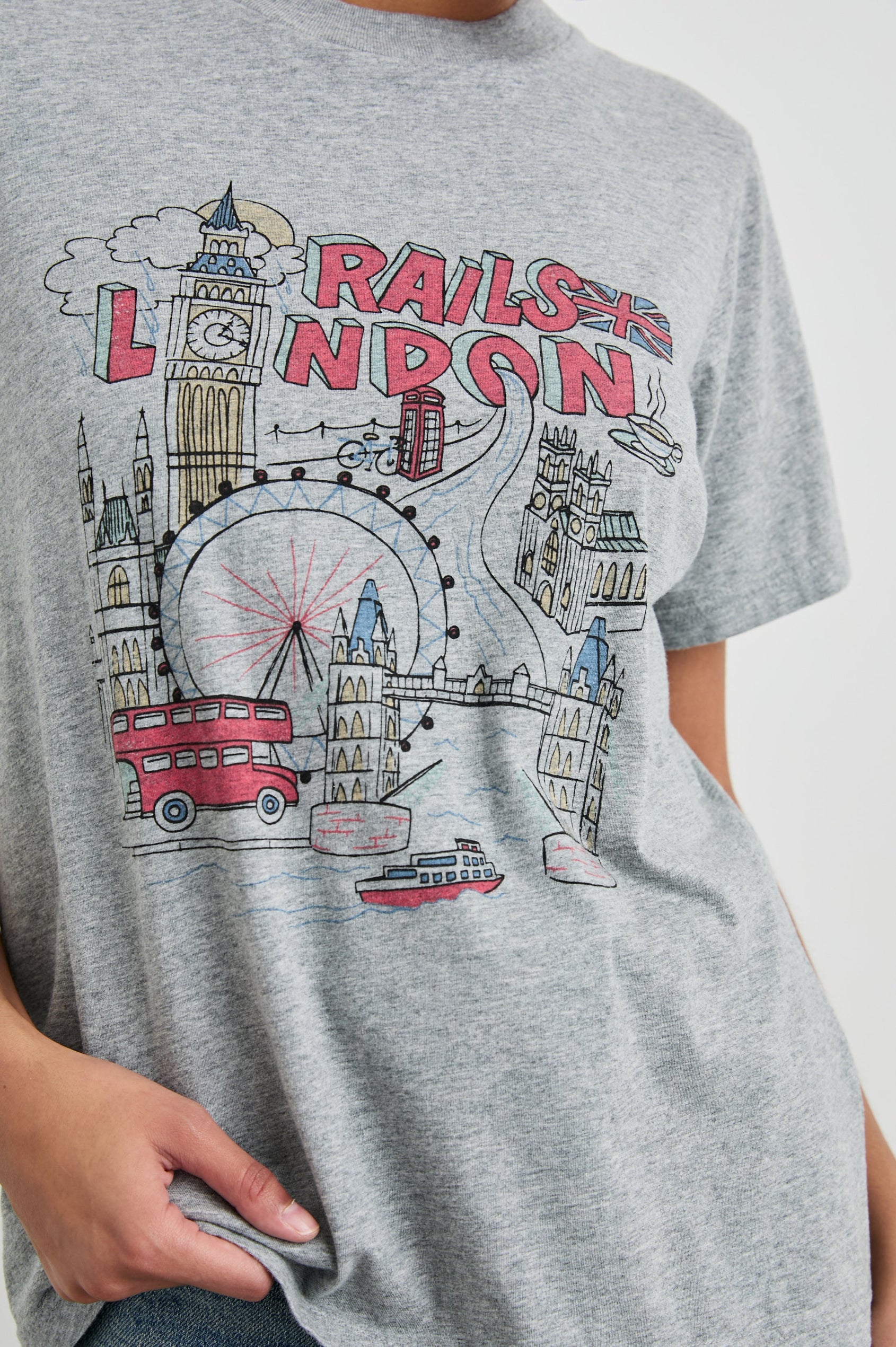 Boyfriend T-Shirt with a Crew Neck, images of London and the text, Rails London in Rails London Colorway, with text and image in pink, yellow and blue on a Grey shirt - Front View Featured on Model