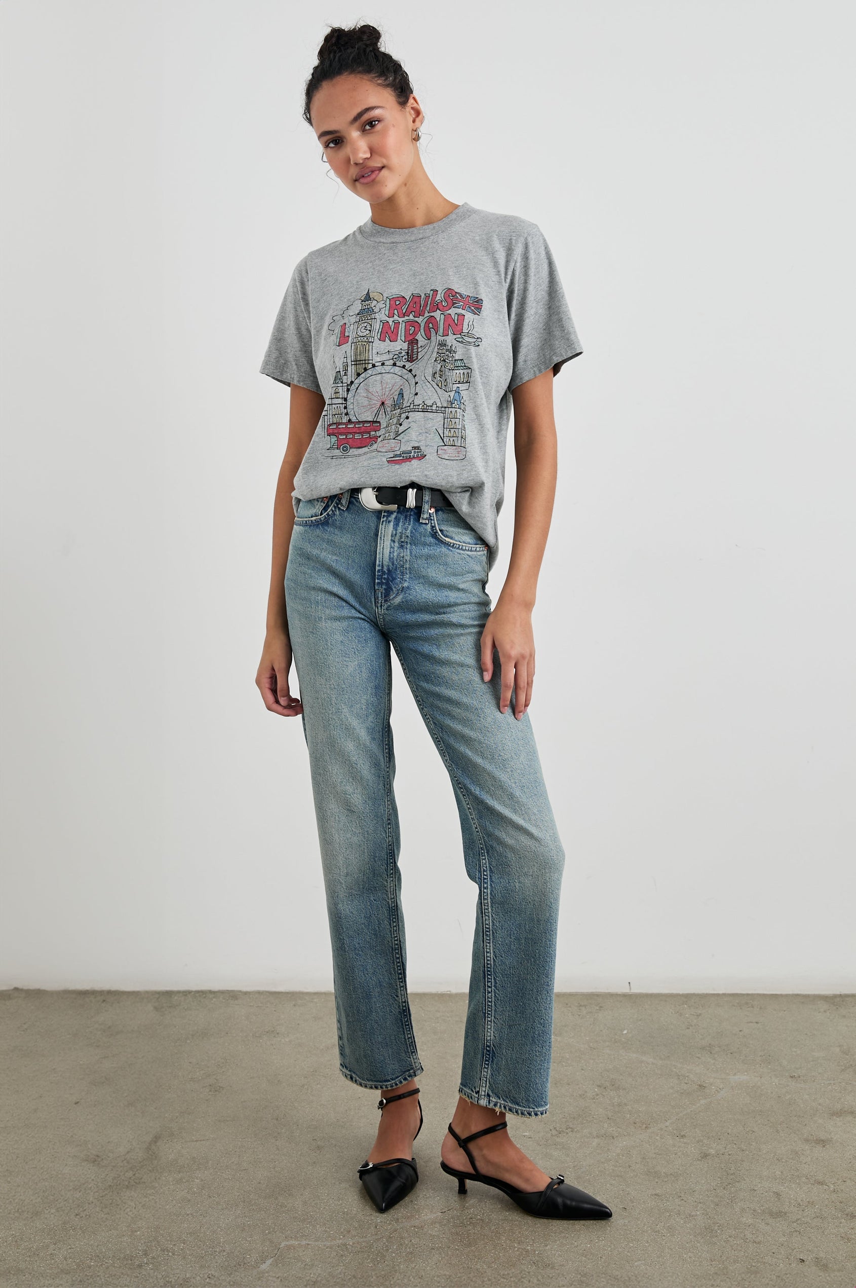 Boyfriend T-Shirt with a Crew Neck, images of London and the text, Rails London in Rails London Colorway, with text and image in pink, yellow and blue on a Grey shirt - Front Tucked Full Body View Featured on Model