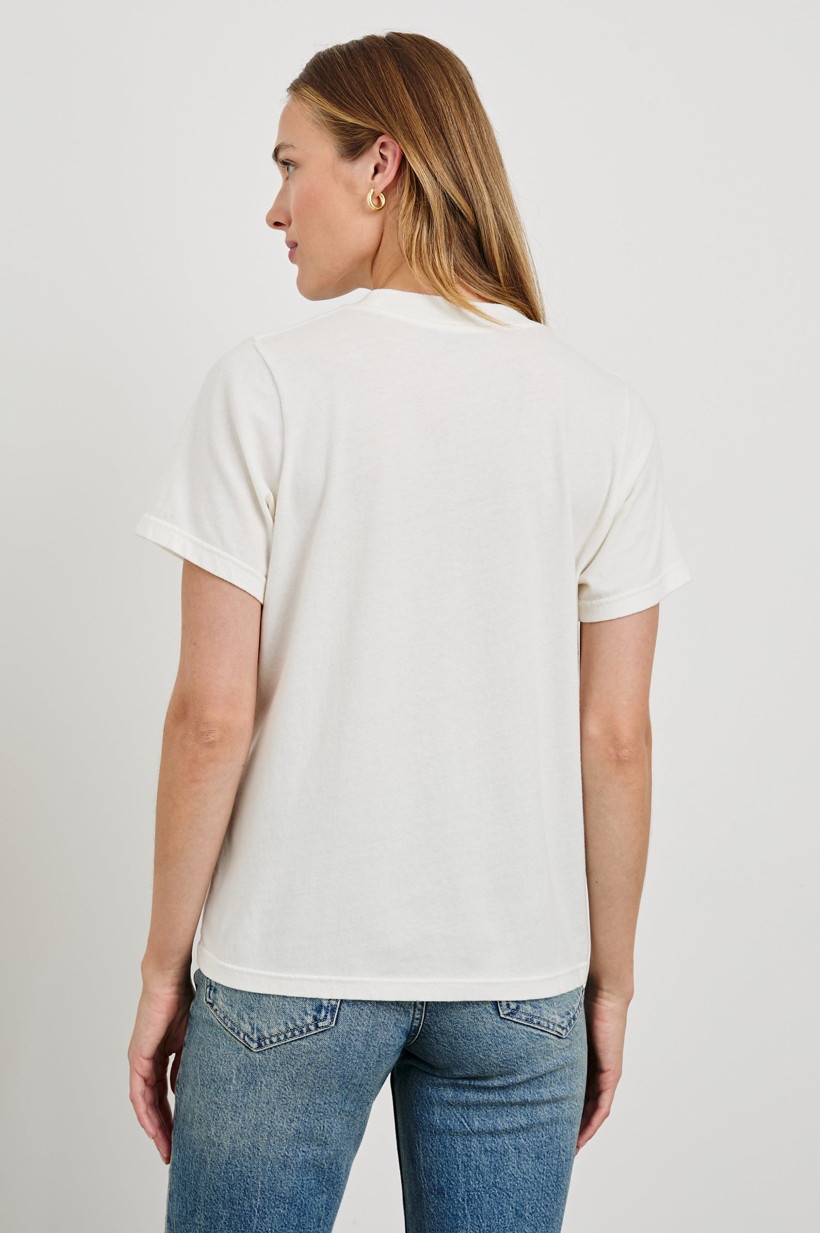 Boyfriend T-Shirt with a Crew Neck, an image of Los Angeles sites and objects, and the text, Rails Los Angeles in Rails Los Angeles Map White Colorway, with text and image in yellow, pink, blue and tan - Back View Featured on Model