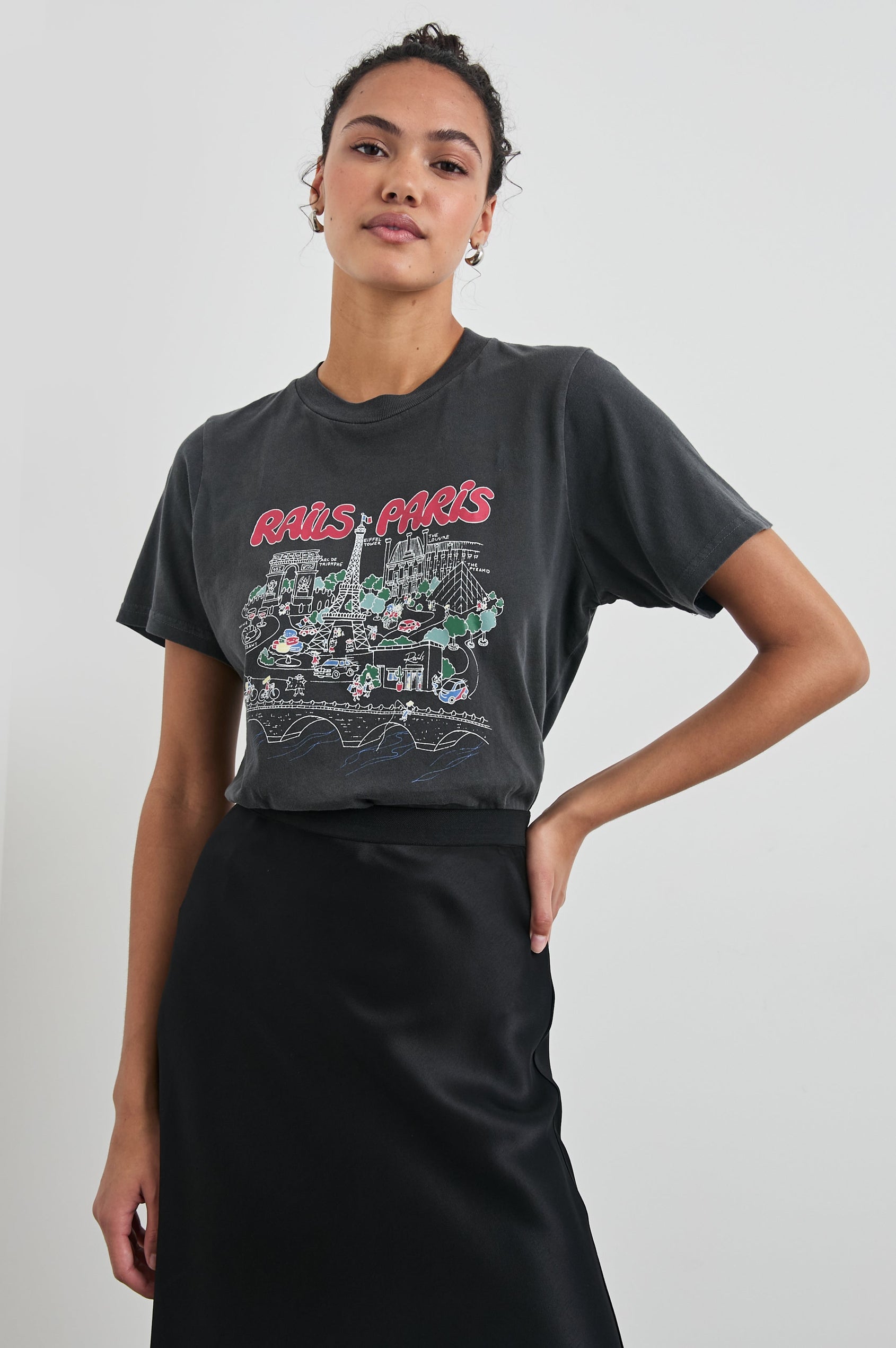Boyfriend T-Shirt with a Crew Neck, Paris Images and the text, Rails Paris in Rails Paris Colorway, with text and images in mostly Pink and white on Black - Front View Featured on Model