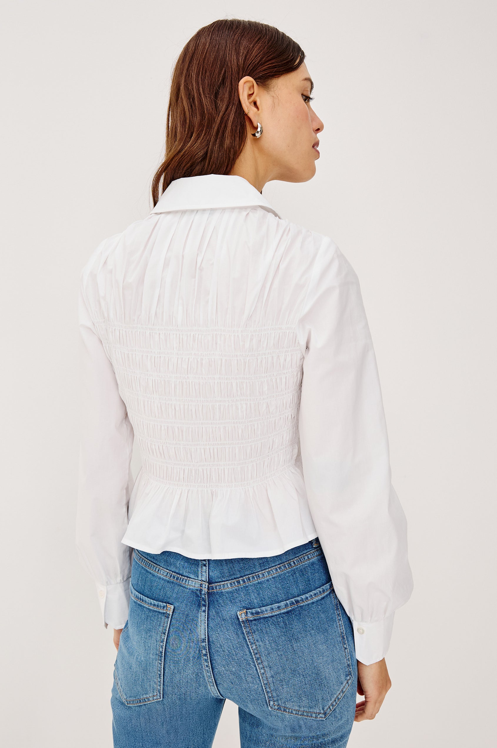 Bradshaw Button-Up Shirt in Cotton Poplin With Collar, Smocked Body, Peplum Hem, and Long Gathered Sleeves in White Colorway - Upper Body Back View Featured on Model