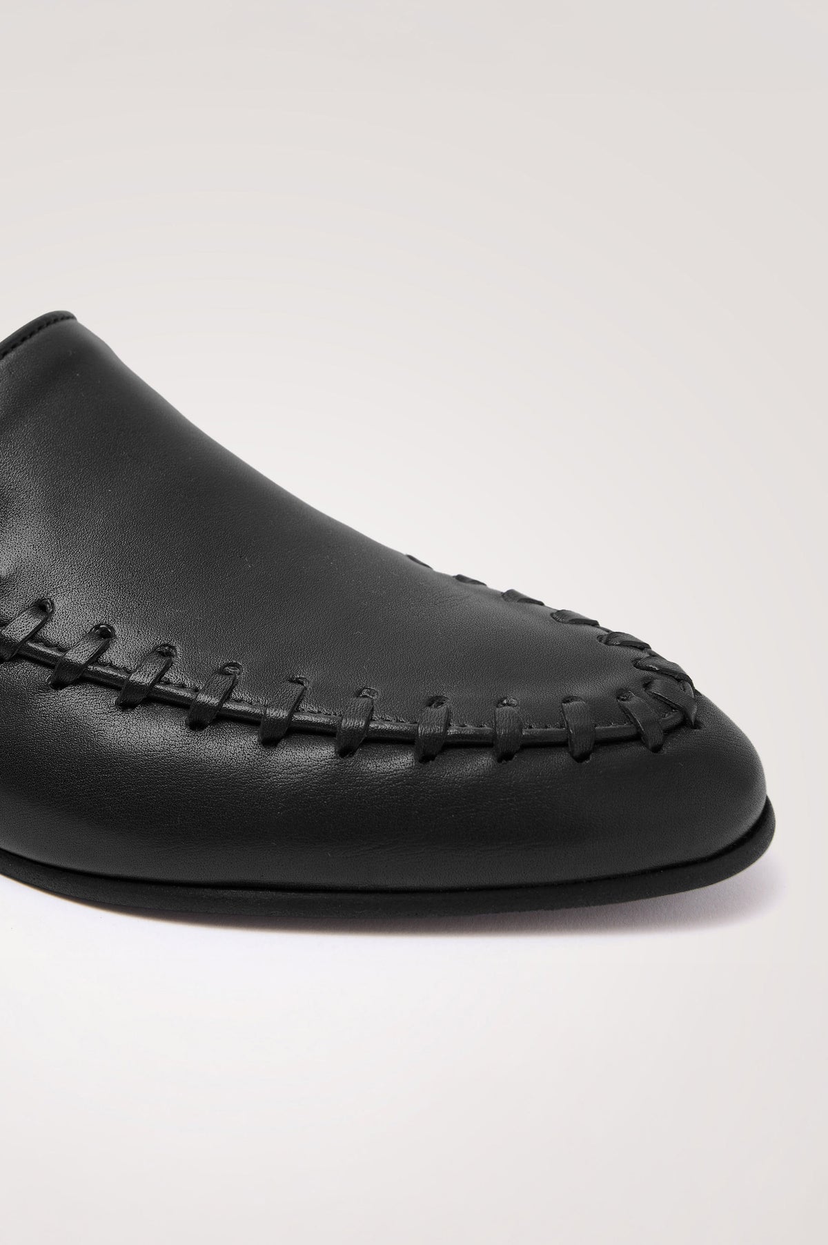 Braga Loafer in Full-Grain Leather With Whipstitch Trim, Narrow Vamp, and Low Heel in Black Colorway - Side Close Up Product View Featured