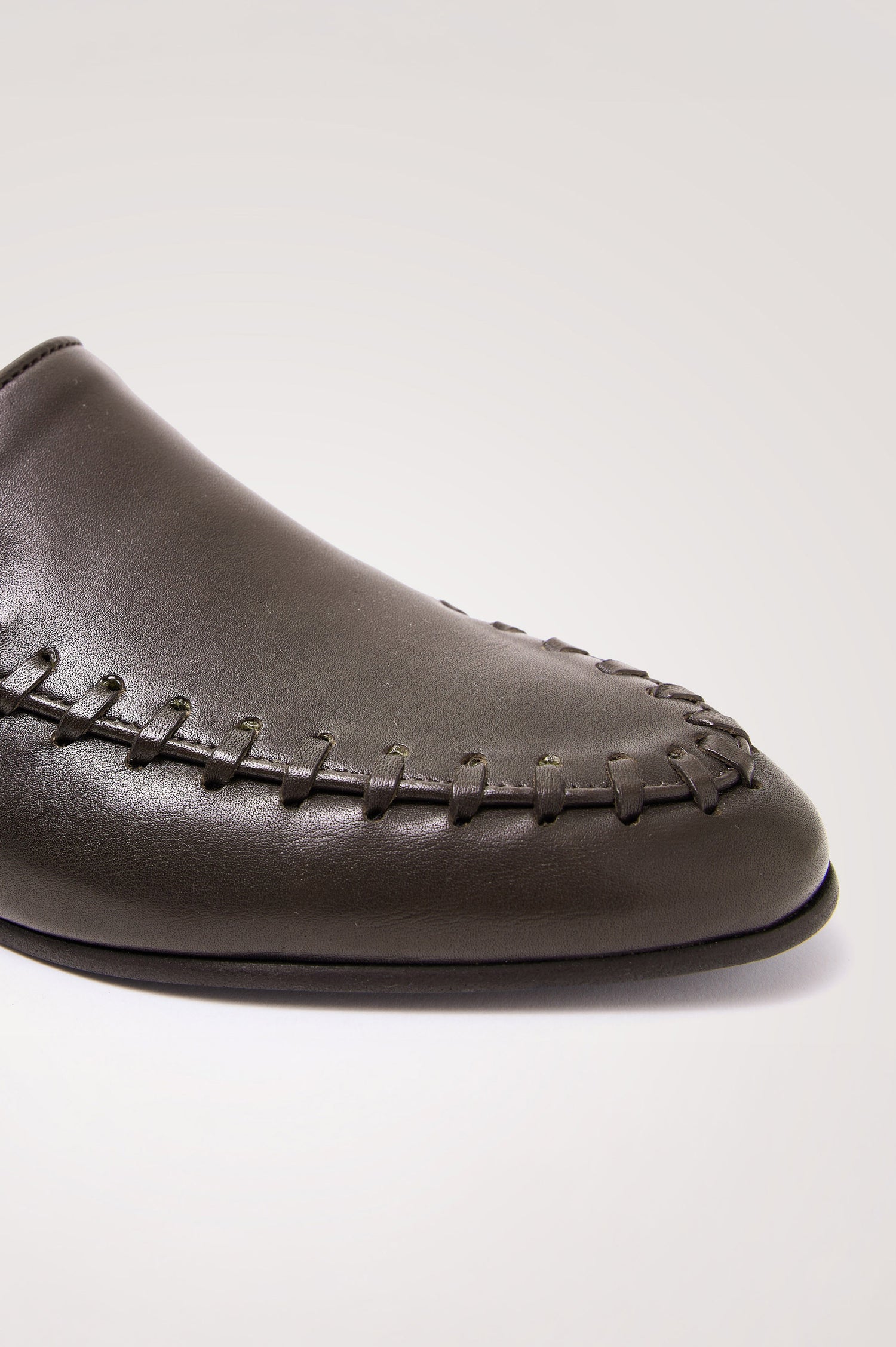 Braga Loafer in Full-Grain Leather With Whipstitch Trim, Narrow Vamp, and Low Heel in Dark Brown Colorway - Side Close Up Product View Featured