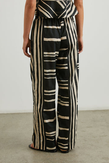 Brendon high-rise Pant with Elastic Waist and two front pockets in Island Stripe Colorway, with white vertical and horizontal stripes on black - Back View Featured on Model