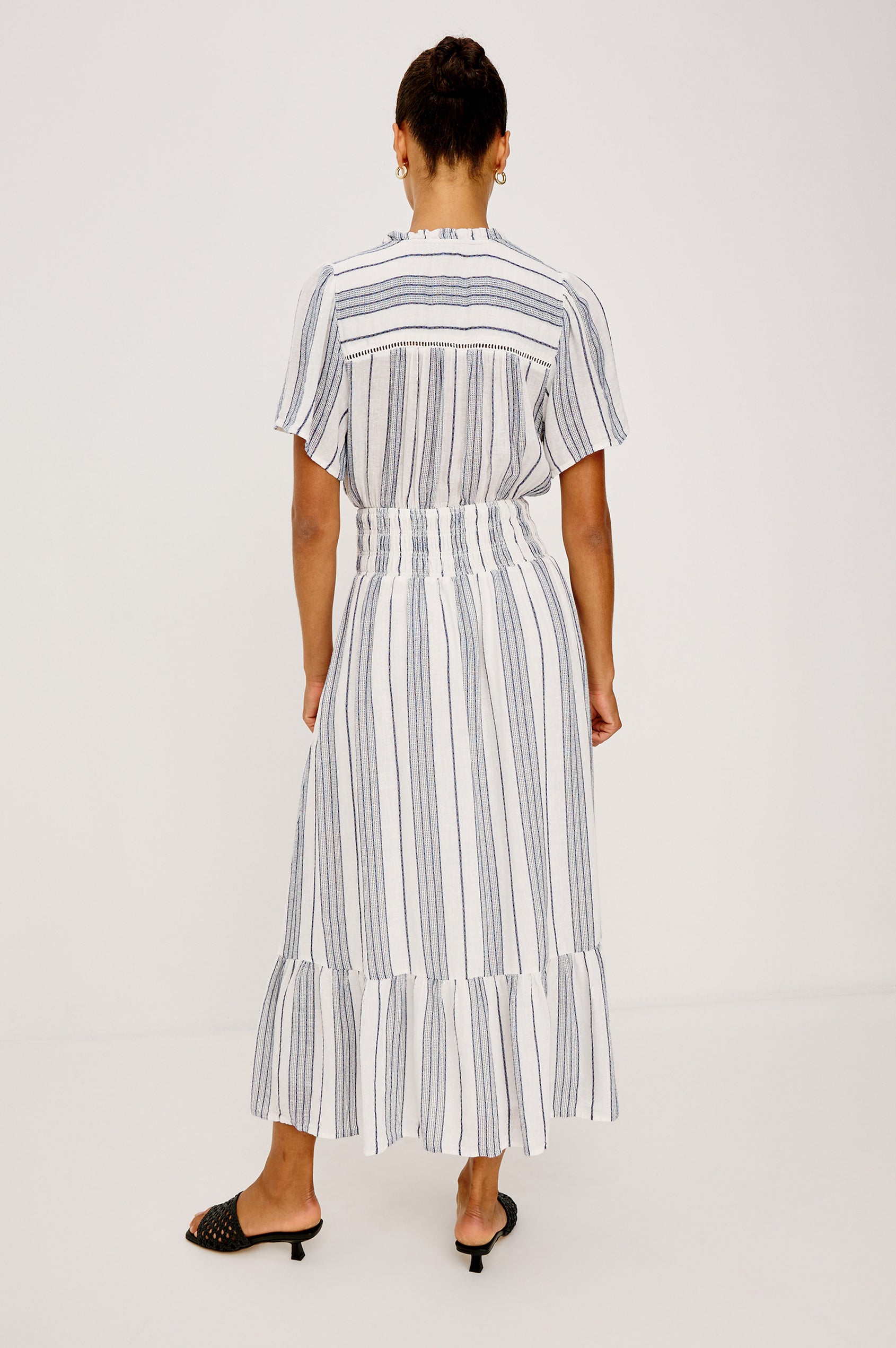 Brent Maxi Dress in Luxe Linen With Front Half Placket, Ladder and Ruffle Trim, Short Wide Sleeves, Smocked Waist, Single-Tier Hem in Salino Stripe Colorway - Full Body Back View Featured on Model