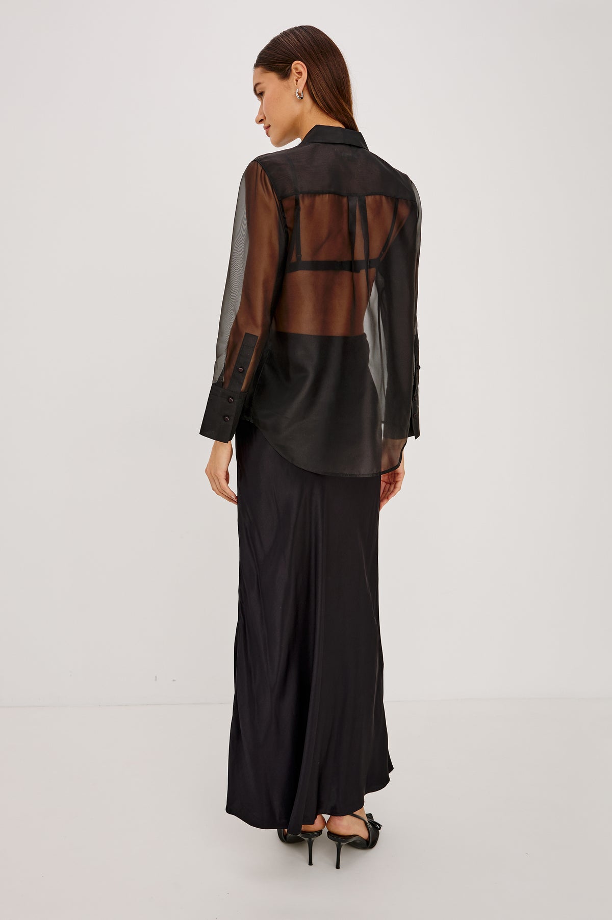 The Bretton Shirt in Sheer Organza With Oversized Fit, Spread Collar, Front Button Placket, and Long Sleeves in Black Organza Colorway - Upper Body Back View Featured on Model.