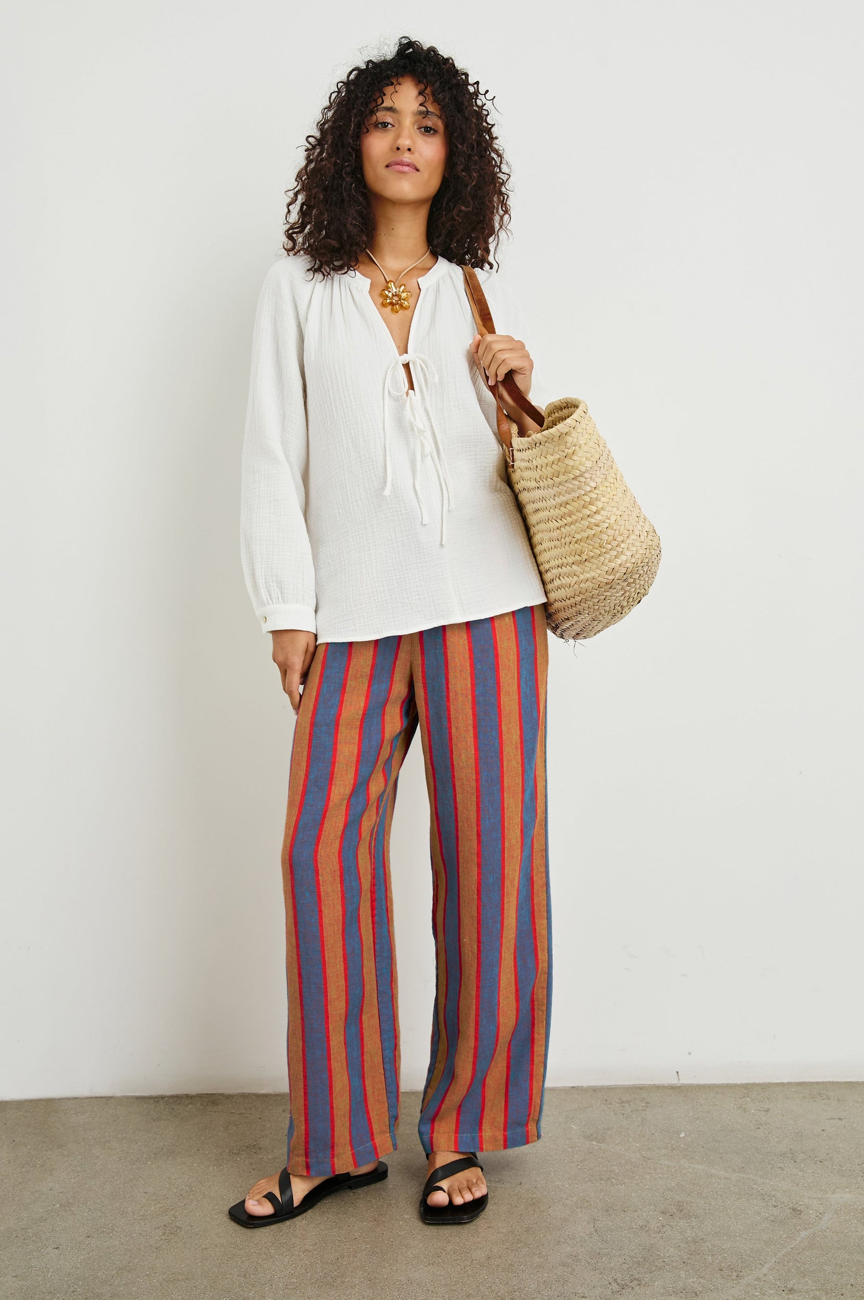 Brielle Long-Sleeve Top with a Deep V Neck with Ties and Pleats around the Neckline in White Colorway - Front View Featured on Model