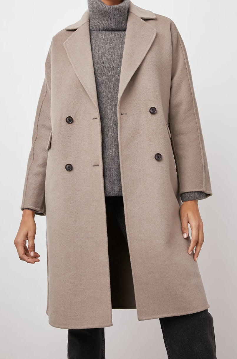 Bristol Knee-Length Double Breasted Coat with Two-Button Closure, Notched Lapels, Two Front Flap Pockets, Center Back Seams, and a Belted Back in Mink Colorway, a Light Brown - Front View Featured on Model  