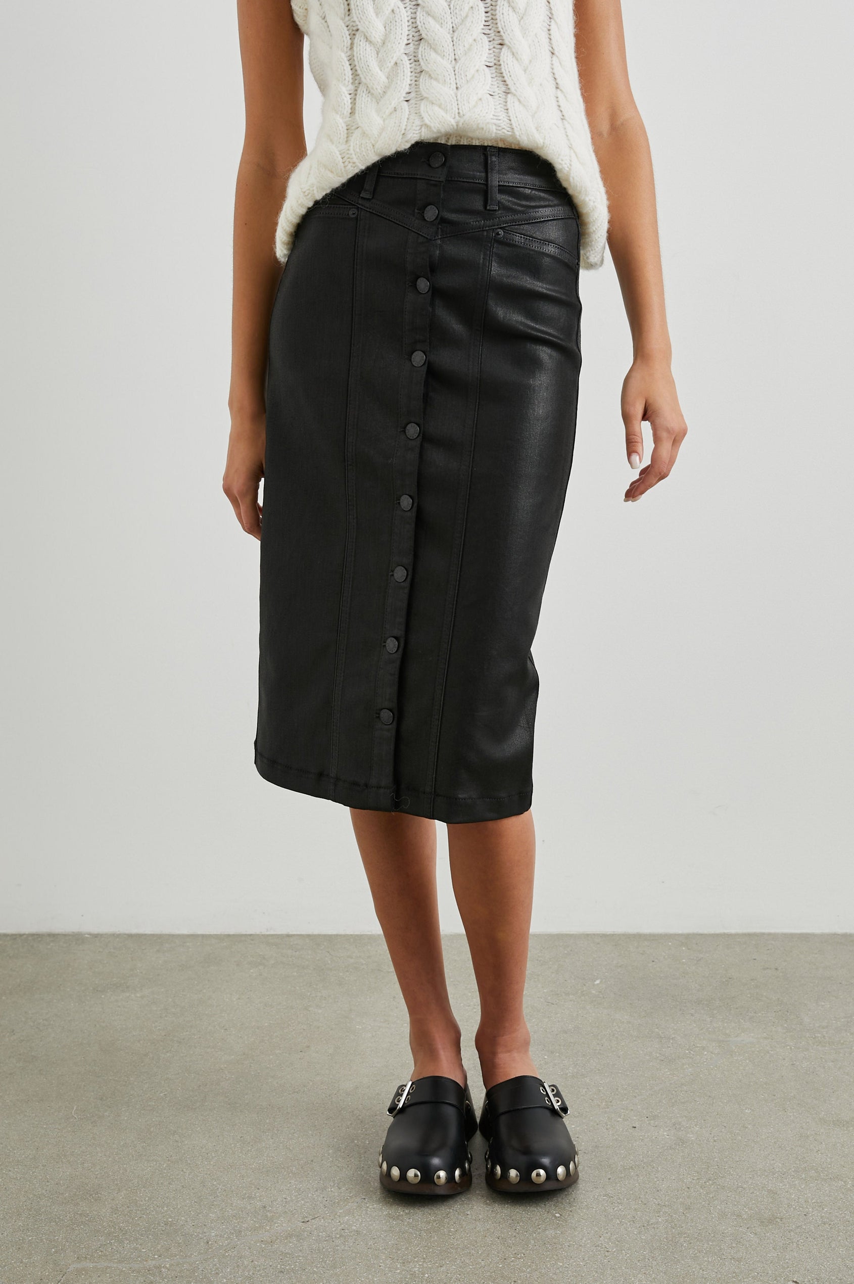 Broadway Midi Skirt with Buttons Down the Front, Belt Loops, Two Front Pockets and Two Back Patch Pockets in Coated Noir Colorway - Front View Featured on Model 