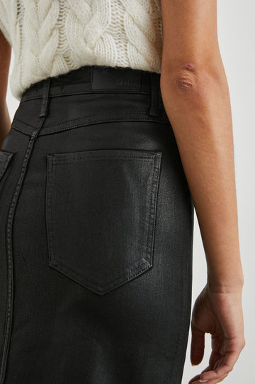 Broadway Midi Skirt with Buttons Down the Front, Belt Loops, Two Front Pockets and Two Back Patch Pockets in Coated Noir Colorway - Back  View Featured on Model 