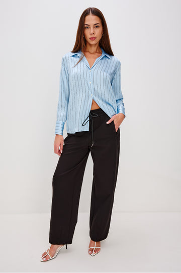 Bronwin Pant in Ponte With Elastic Waistband With Adjustable Ties, Side Zip Pockets, and Barrel Hem in Black Colorway - Full Body Front View Featured on Model