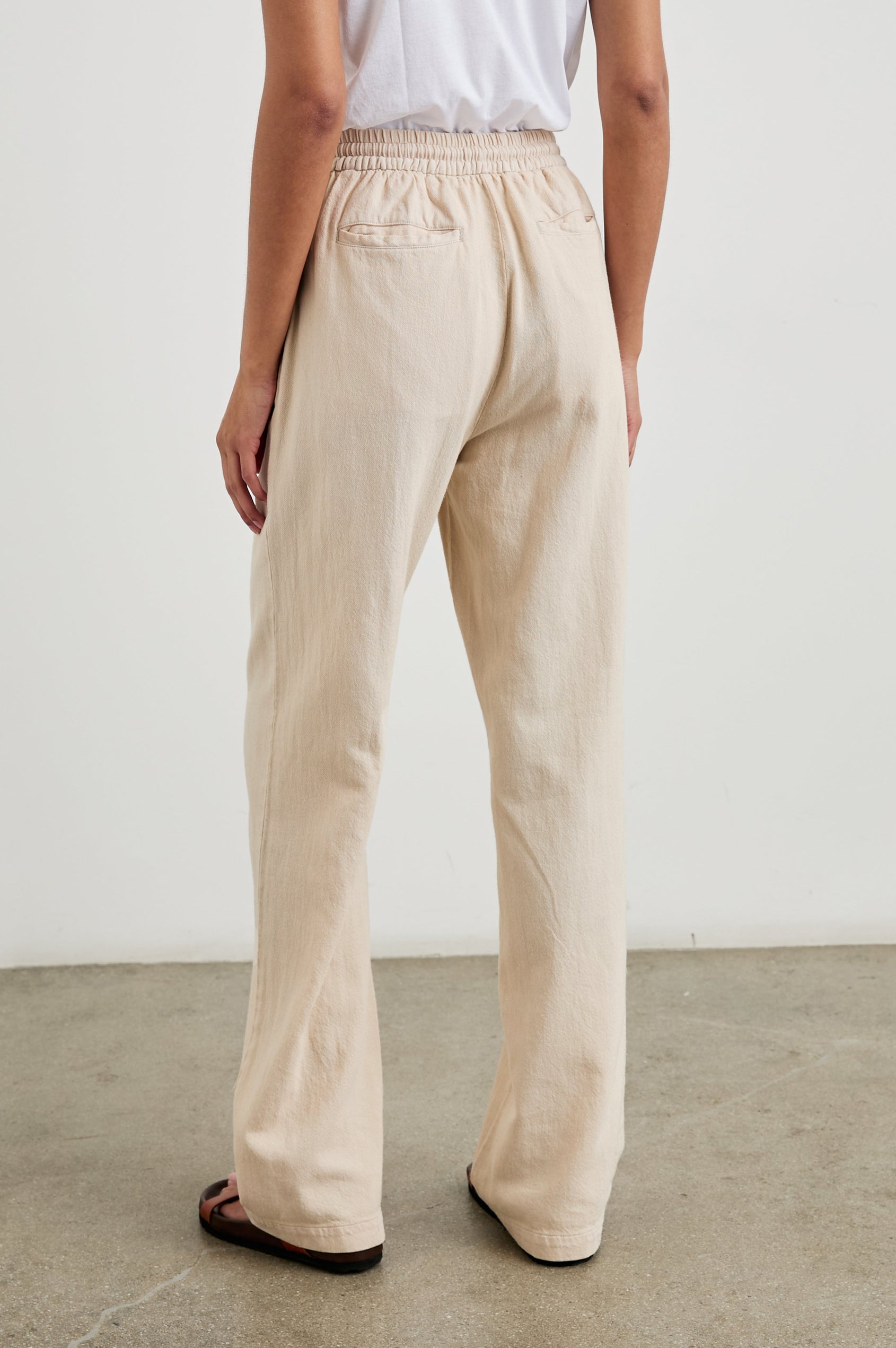 Brooklyn Pants with a Drawcord Elastic Waist, Two Front Pockets and Two Back Welt Pockets in Stone Colorway - Back View Featured on Model