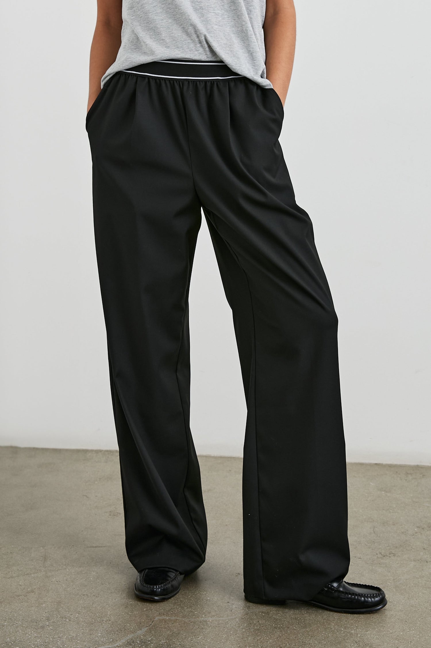 Brynn Pants with Two Front Pockets and Elastic Waist Band with White Trim in Black Colorway - Front View Featured on Model
