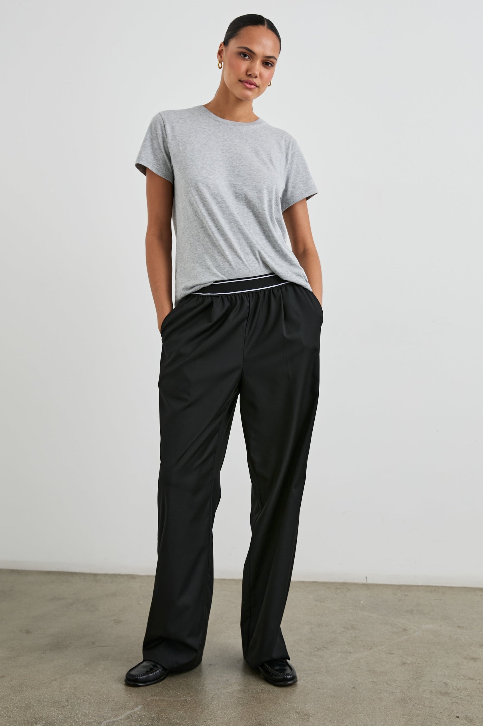 Brynn Pants with Two Front Pockets and Elastic Waist Band with White Trim in Black Colorway - Front Full Body View Featured on Model