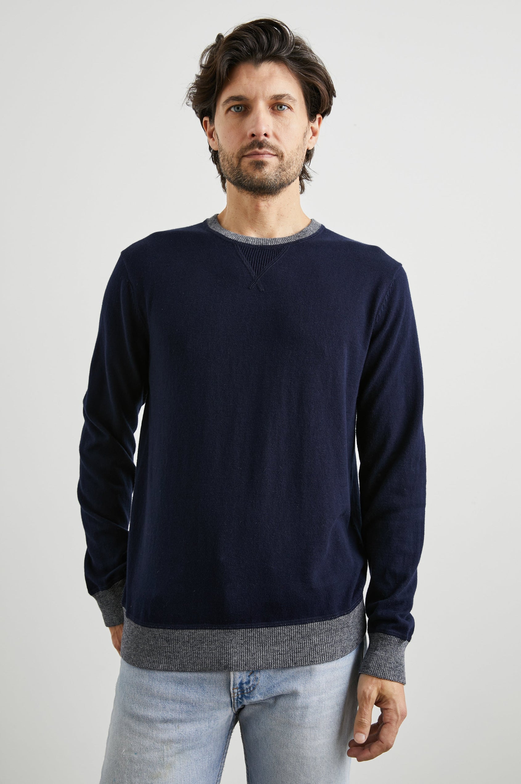 Burns Long-Sleeve Sweater with a Crew Collar and a Lighter Colored Ribbed Trim in Perfect Navy Colorway - Front View Featured on Model