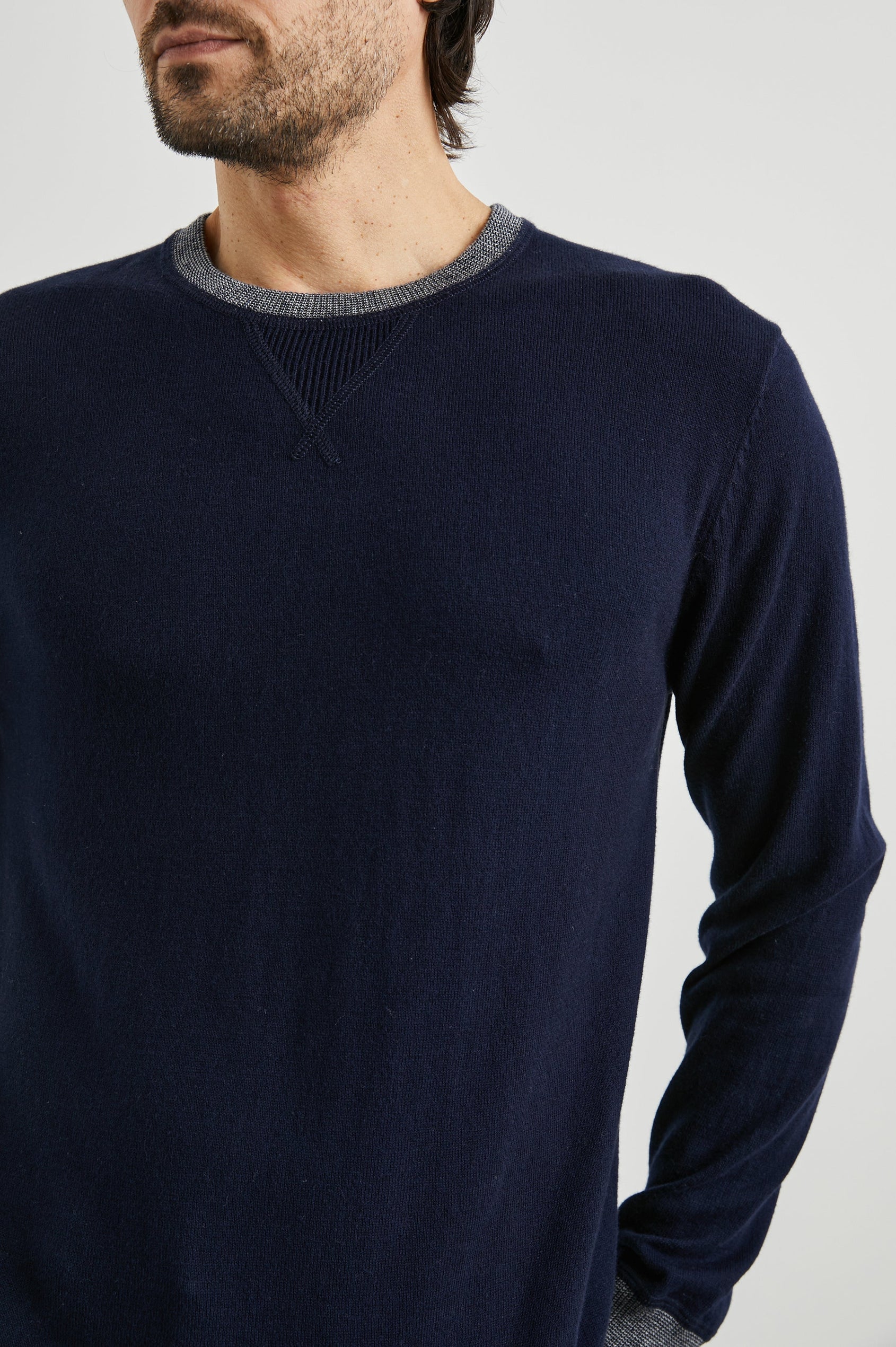 Burns Long-Sleeve Sweater with a Crew Collar and a Lighter Colored Ribbed Trim in Perfect Navy Colorway - Front View Featured on Model