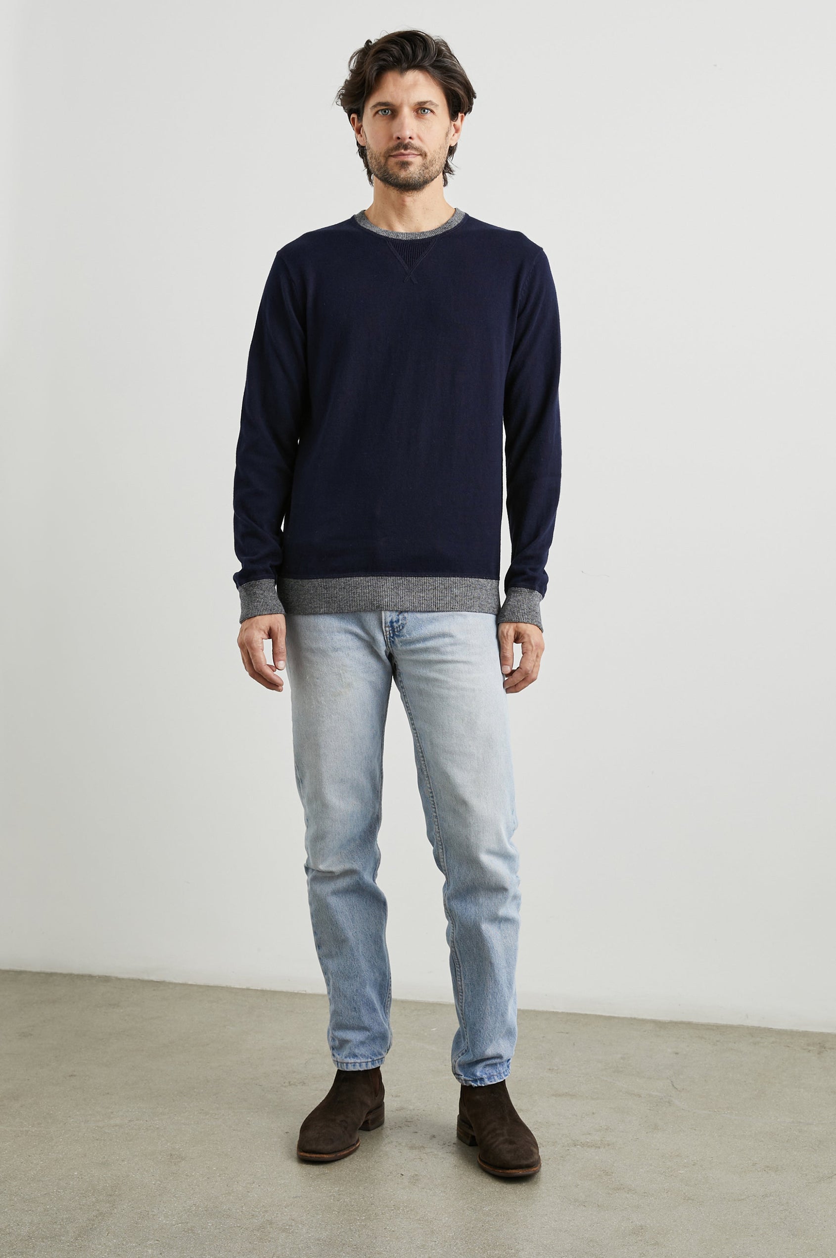 Burns Long-Sleeve Sweater with a Crew Collar and a Lighter Colored Ribbed Trim in Perfect Navy Colorway - Front Full Body View Featured on Model