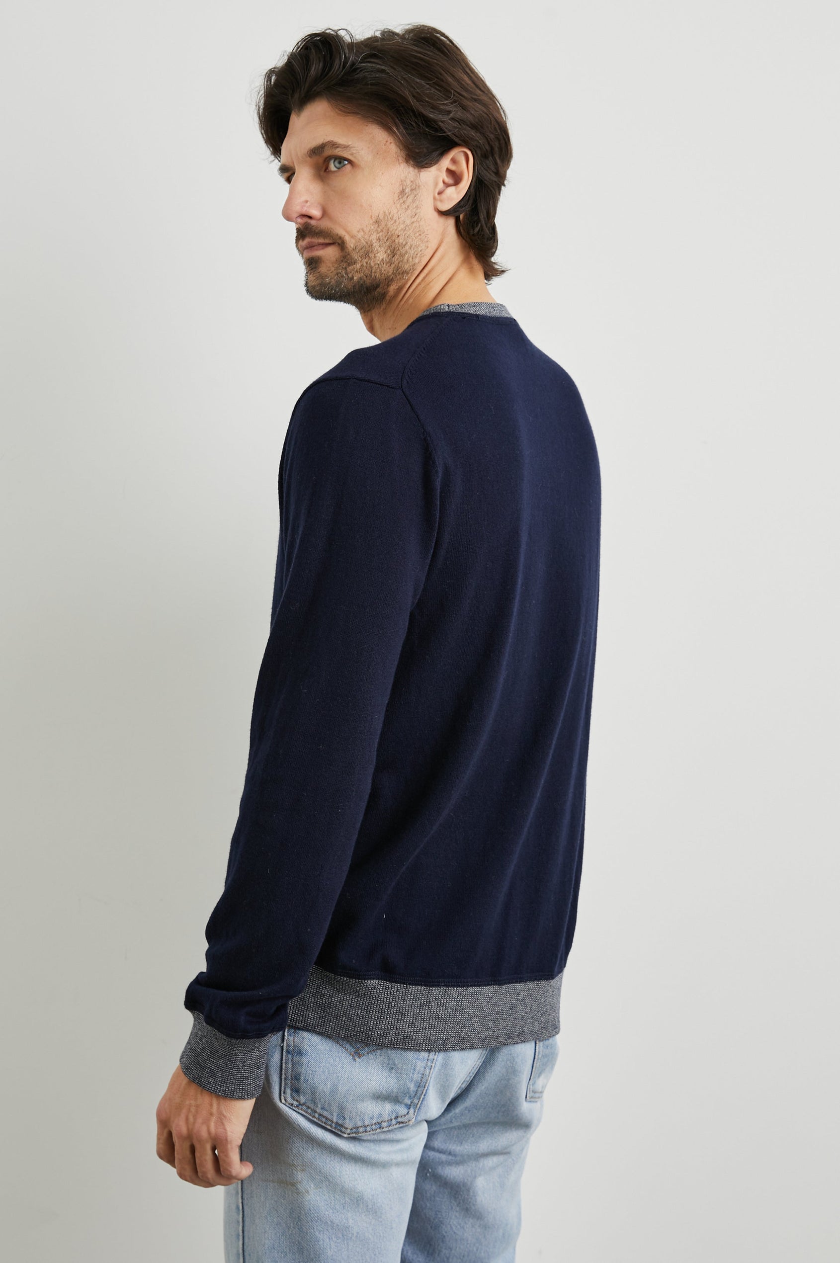 Burns Long-Sleeve Sweater with a Crew Collar and a Lighter Colored Ribbed Trim in Perfect Navy Colorway - Back View Featured on Model