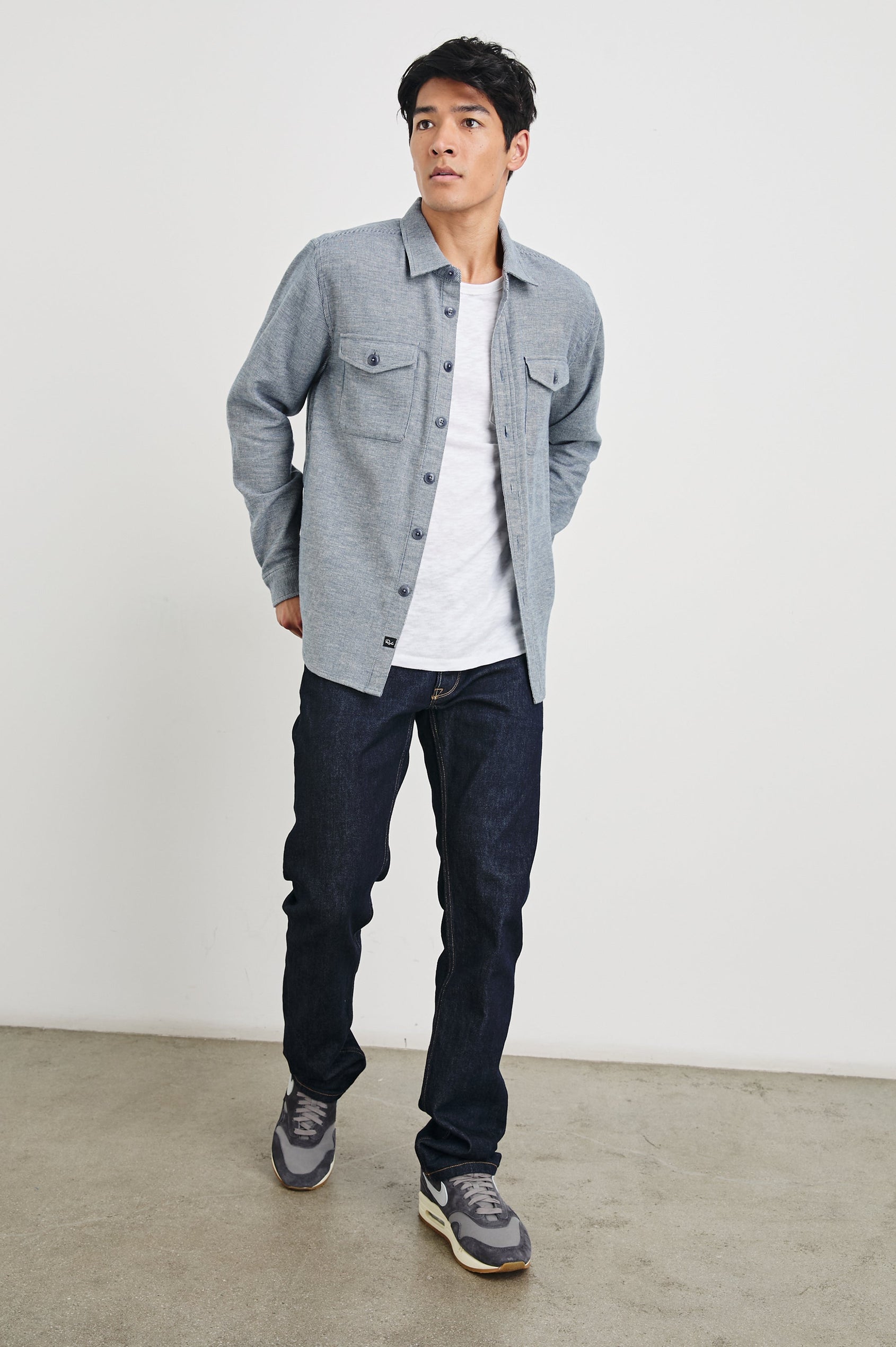 Burr Collared Shirt Jacket with Button Closure, Two Chest Button Flap Pockets and Textured Fabric in Denim White Colorway - Front Unbuttoned Full Body View Featured on Model