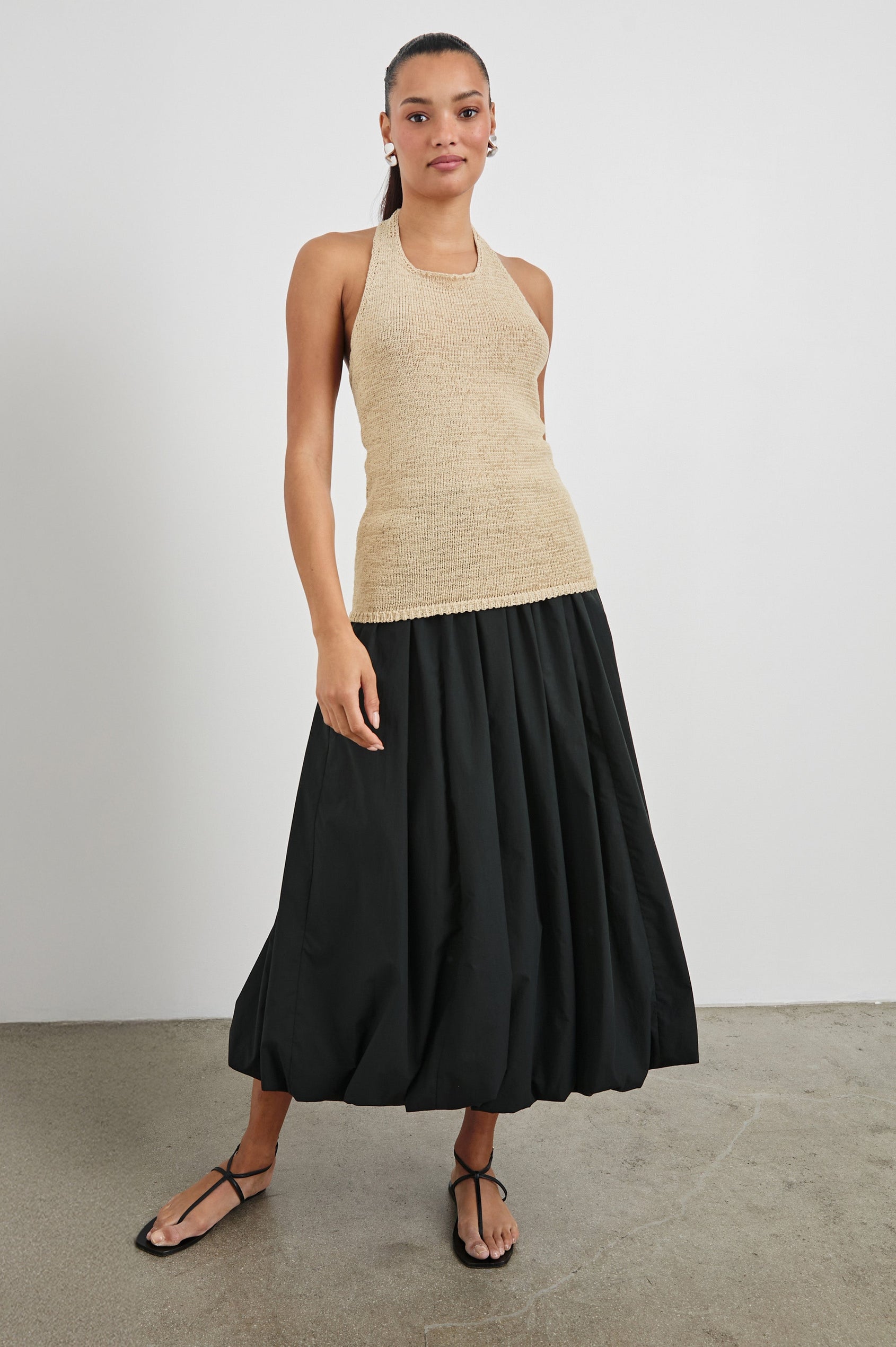 Cala midi length bubble skirt with elastic waistband and side pockets in Black - front view on model