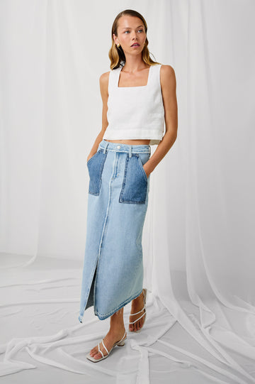 Calabasas high rise, long skirt with front slit and contrast wash pockets in Tattered Patchwork - front view on model, hands in pocket