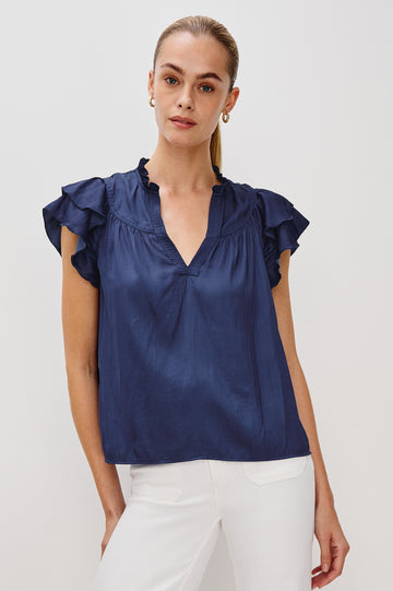 Calista V-Neck Ruffle Sleeve Blouse with a Ruffled Neckline and Gathered Front Yoke in Admiral Blue Colorway. Front View Shown on Model.