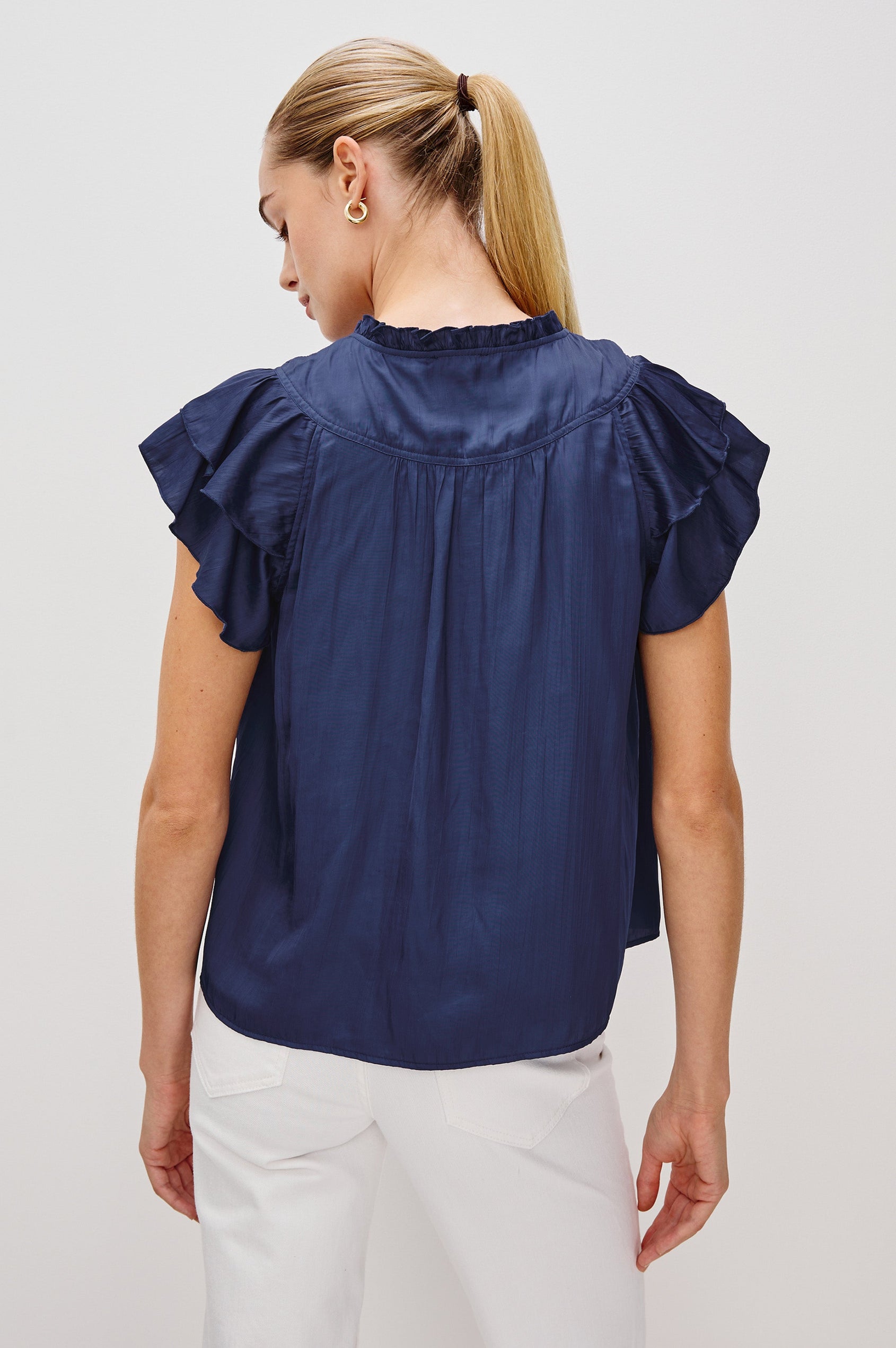 Calista V-Neck Ruffle Sleeve Blouse with a Ruffled Neckline and Gathered Front Yoke in Admiral Blue Colorway. Back View Shown on Model.