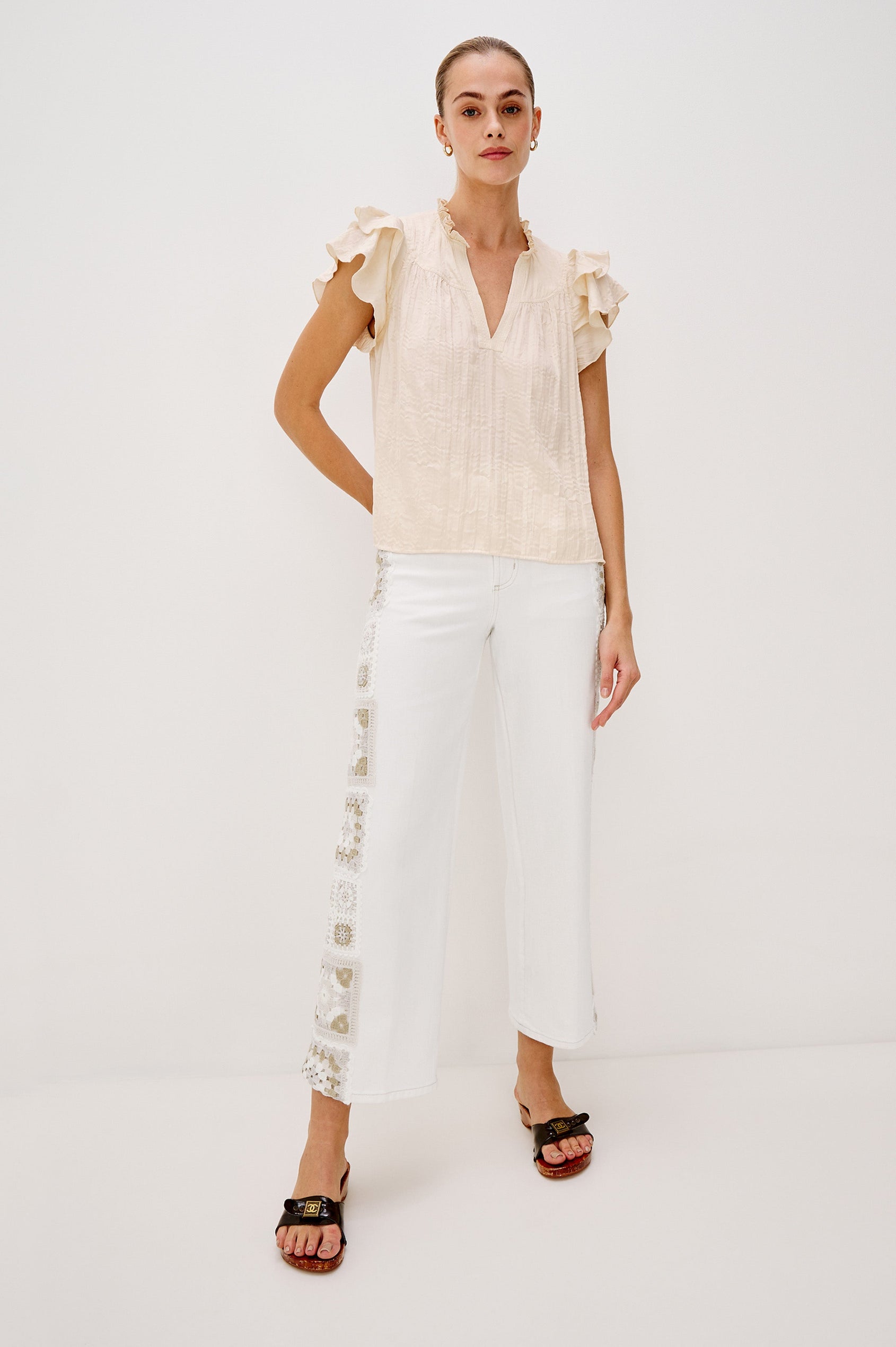 Calista V-Neck Ruffle Sleeve Blouse with a Ruffled Neckline and Gathered Front Yoke in Ivory Colorway. Full Body Front View Shown on Model.
