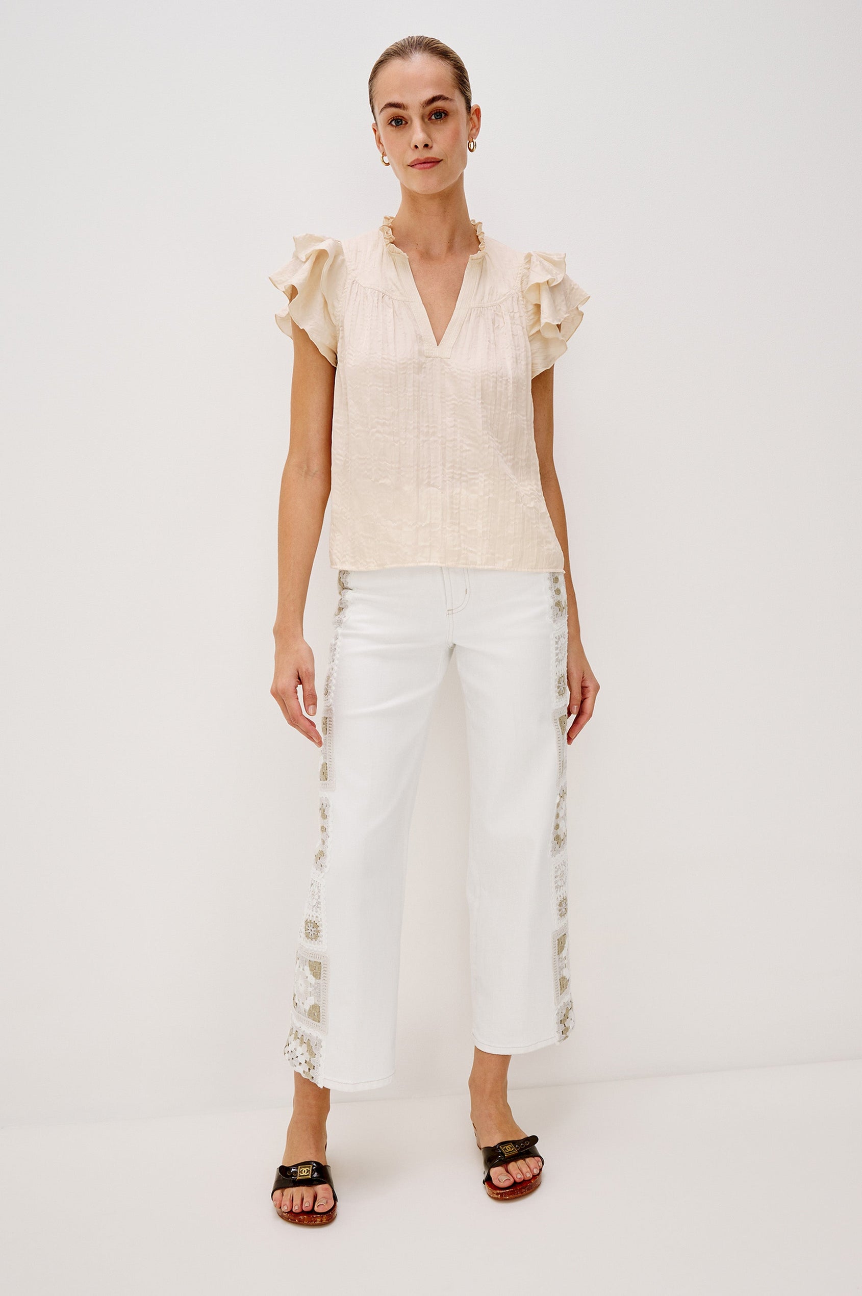 Calista V-Neck Ruffle Sleeve Blouse with a Ruffled Neckline and Gathered Front Yoke in Ivory Colorway. Full Body Back View Shown on Model.