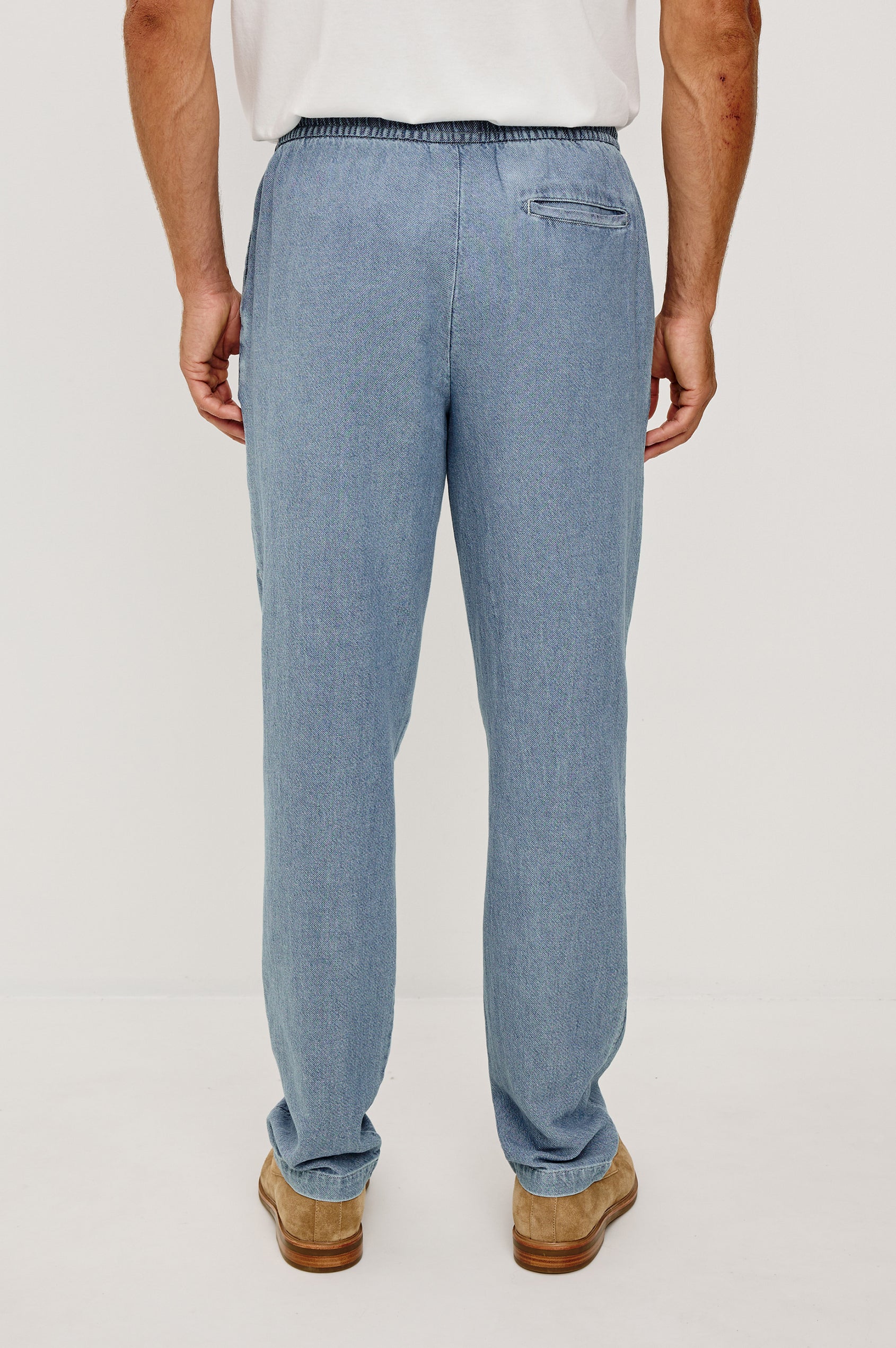 Callum Tapered Straight Leg Pant in Linen Twill With Adjustable Drawstring Waistband Ties in Medium Wash Indigo Colorway - Lower Body Back View Featured on Model