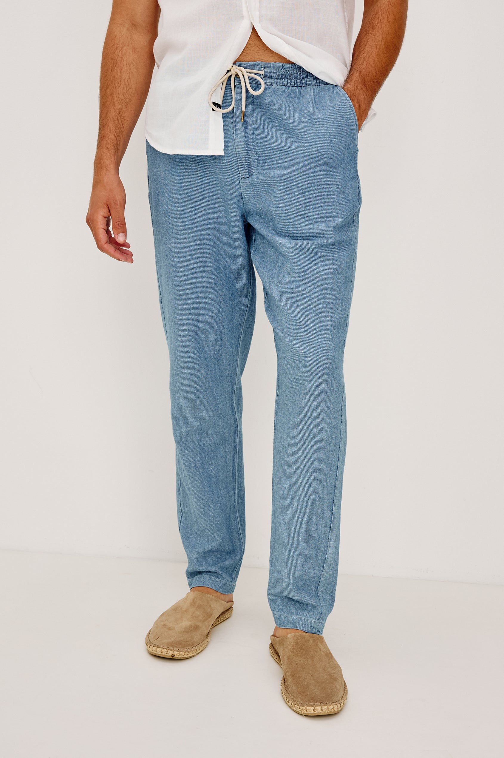 Callum Tapered Straight Leg Pant in Linen Twill With Adjustable Drawstring Waistband Ties in Medium Wash Indigo Colorway - Lower Body Front View Featured on Model
