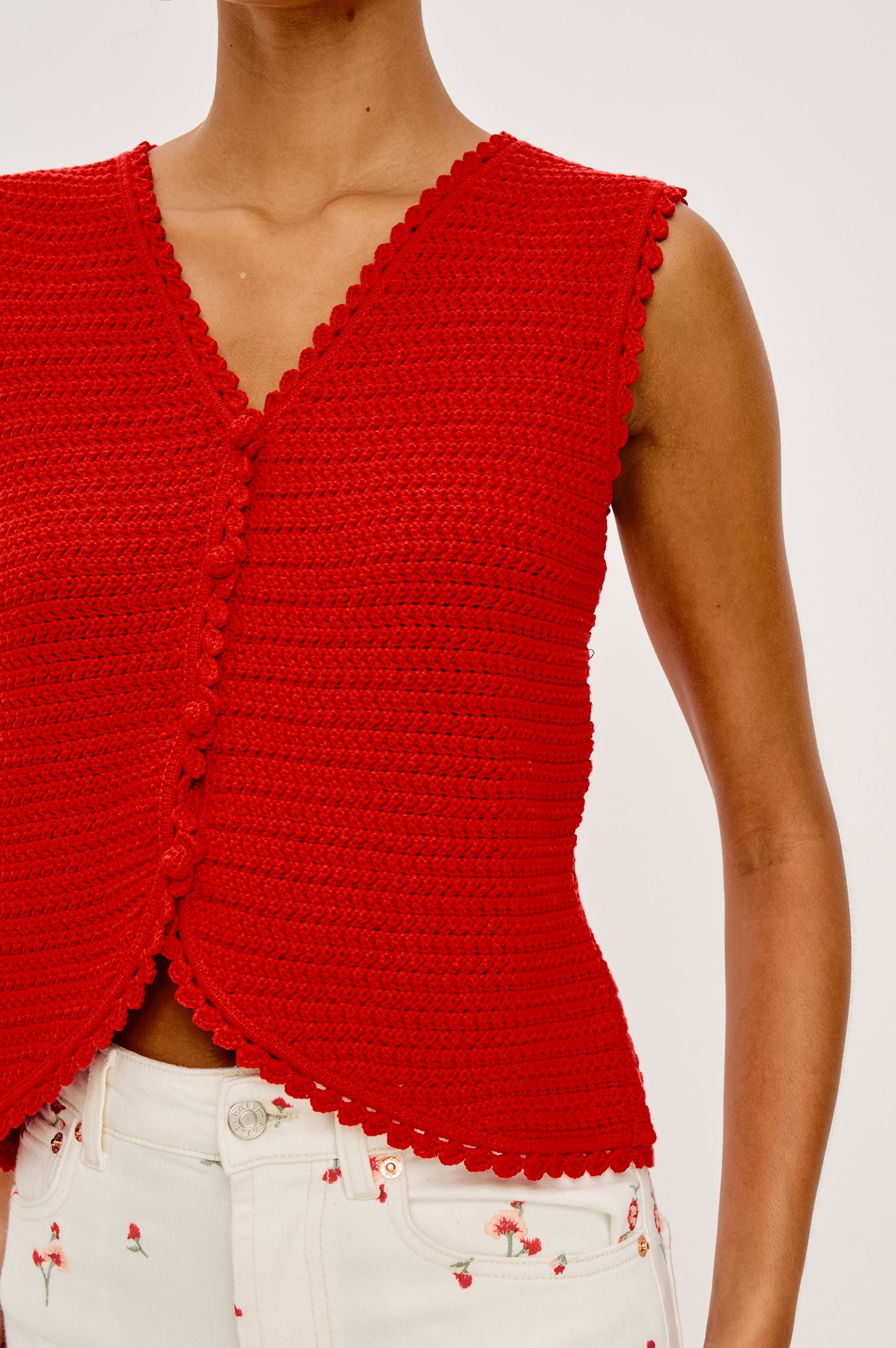 Calypso Knit Sleeveless Vest Top With Front Buttons and Relaxed Fit in Scarlet Colorway - Upper Body Close Up Front View Featured on Model