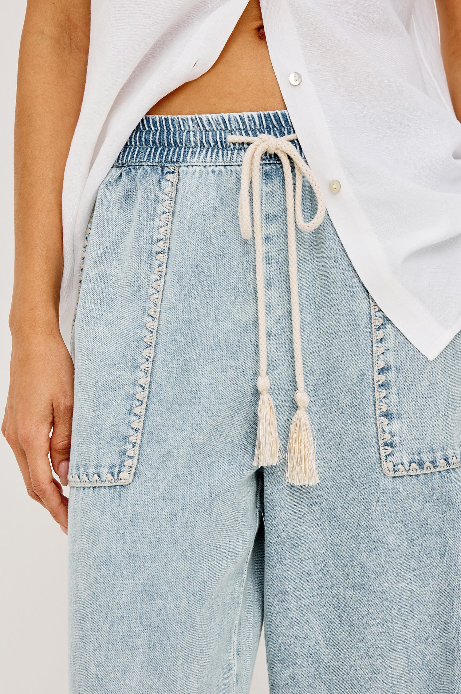 Campo Jean in Cotton Lyocell Denim With Blanket Stitching, Elastic Waist, Side Pockets, and Single Back Pocket in Indigo Blanket Stitch Colorway - Lower Body Front View Featured on Model