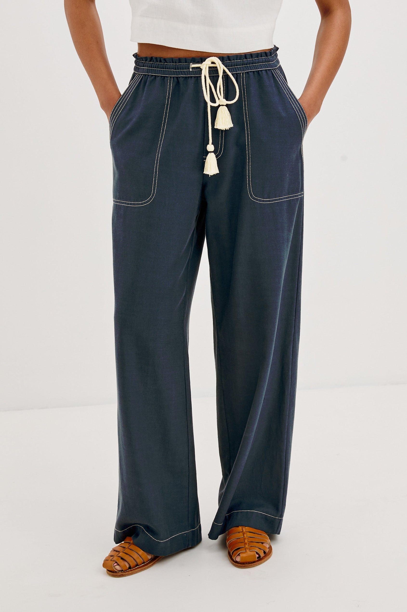 Campo Wide Leg Pant with Drawstring Waistband, Front Utility Patch Pockets and Contrast White Stitching in Navy Colorway. Front View Shown on Model.