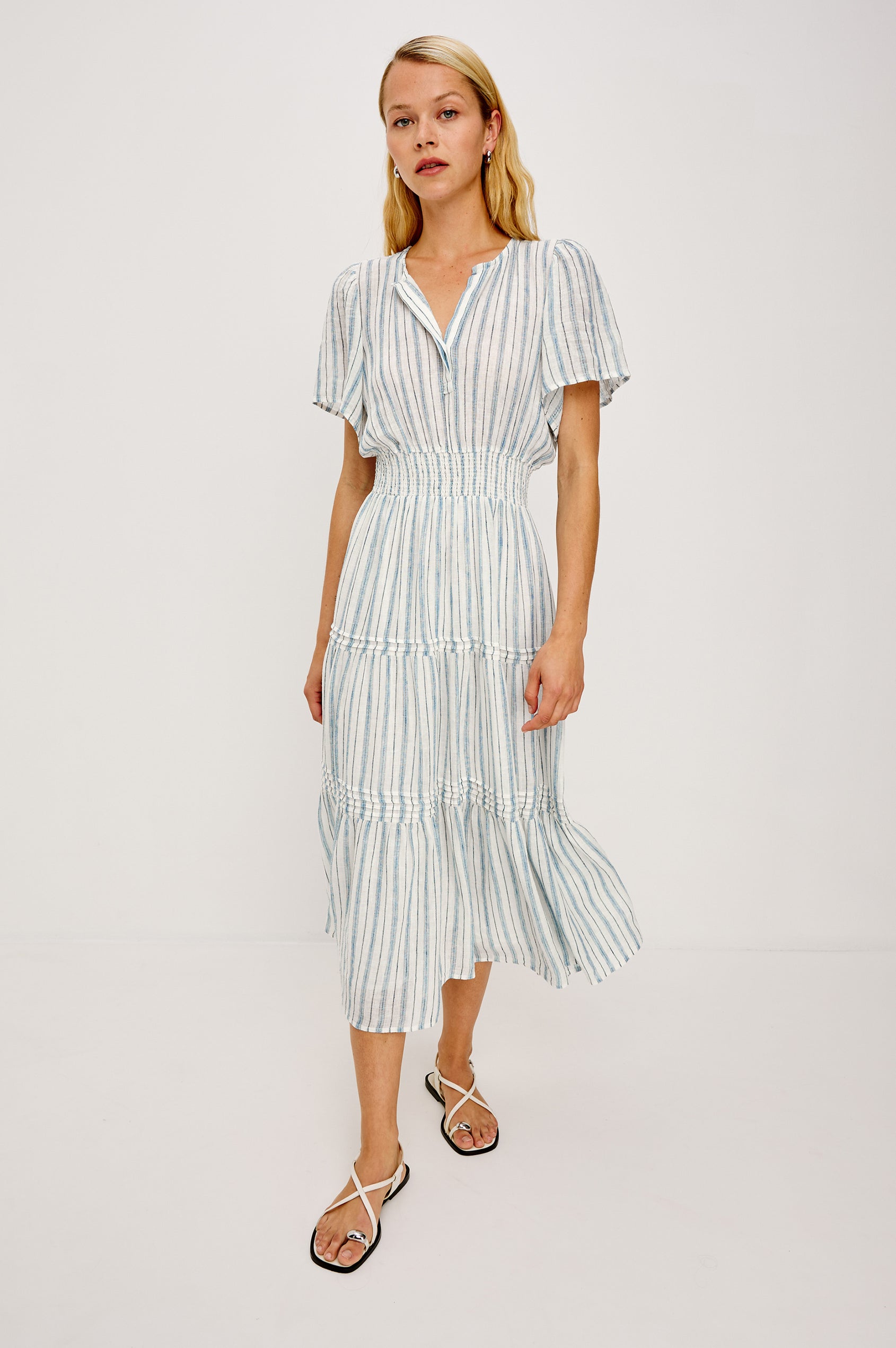 Cannes Midi in Linen With Half Placket Neckline Short Sleeves Smocked Waist and Tiered Skirt in Windward Stripe - Full Body Front View Featured on Model