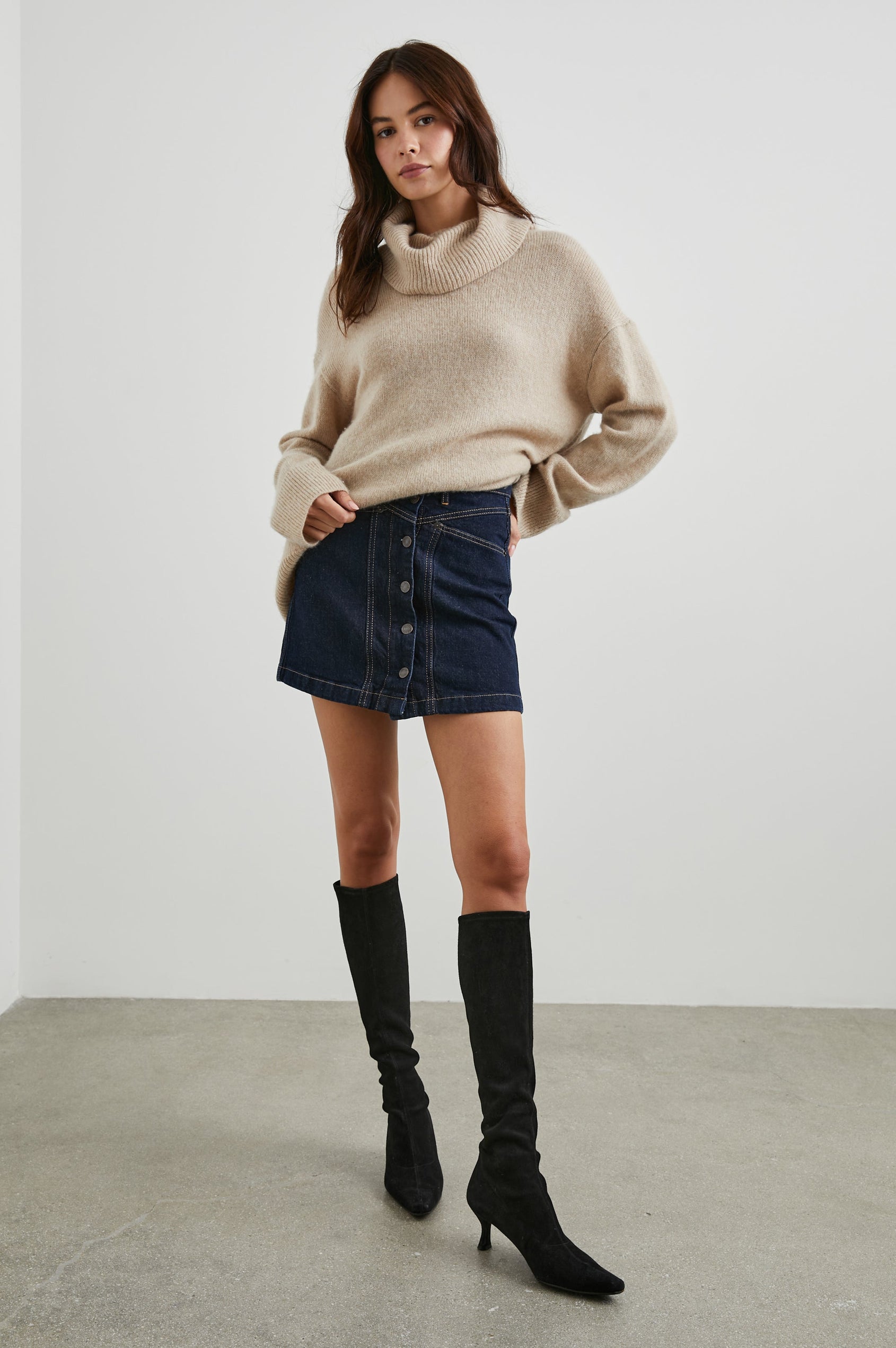 Canyon Denim Mini Skirt with a Full Button Front, Belt Loops, Two Front Pockets and Two Back Patch Pockets in Midnight Blues Colorway - Front Full Body View Featured on Model