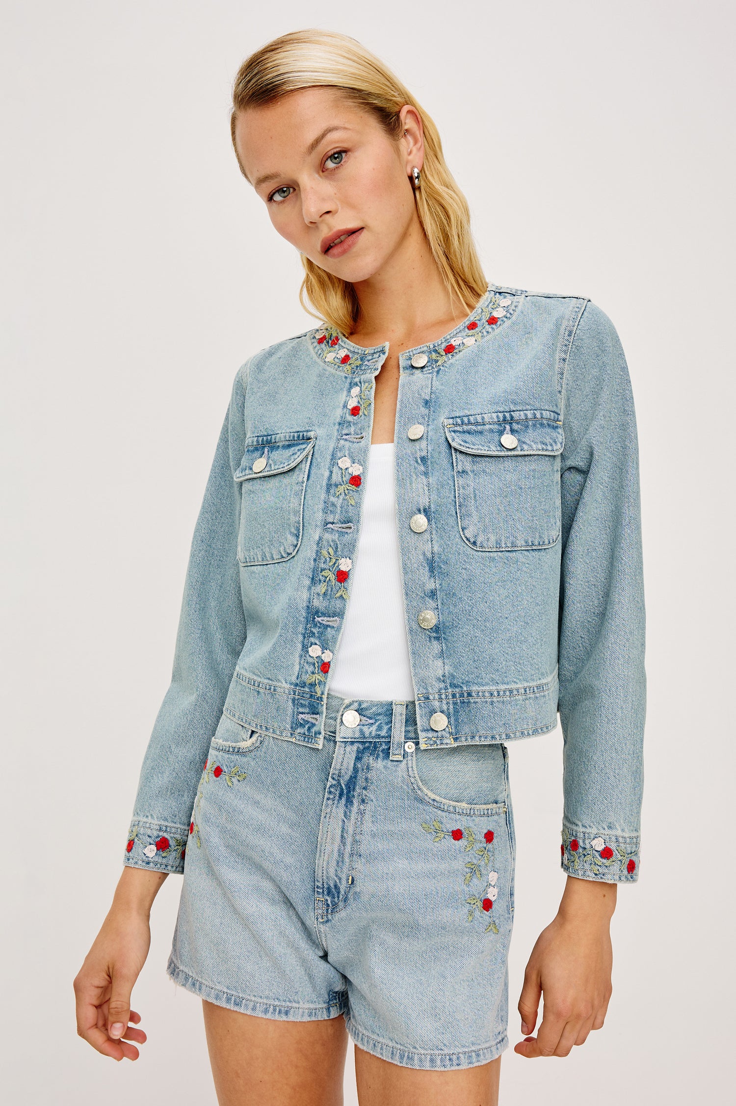Capistrano Lady Jacket in Recycled Cotton Denim Blend With Floral Embroidery, Chest Flap Buttoned Pockets, and Long Sleeves in Dainty Rose Colorway - Upper Body Front View Featured on Model