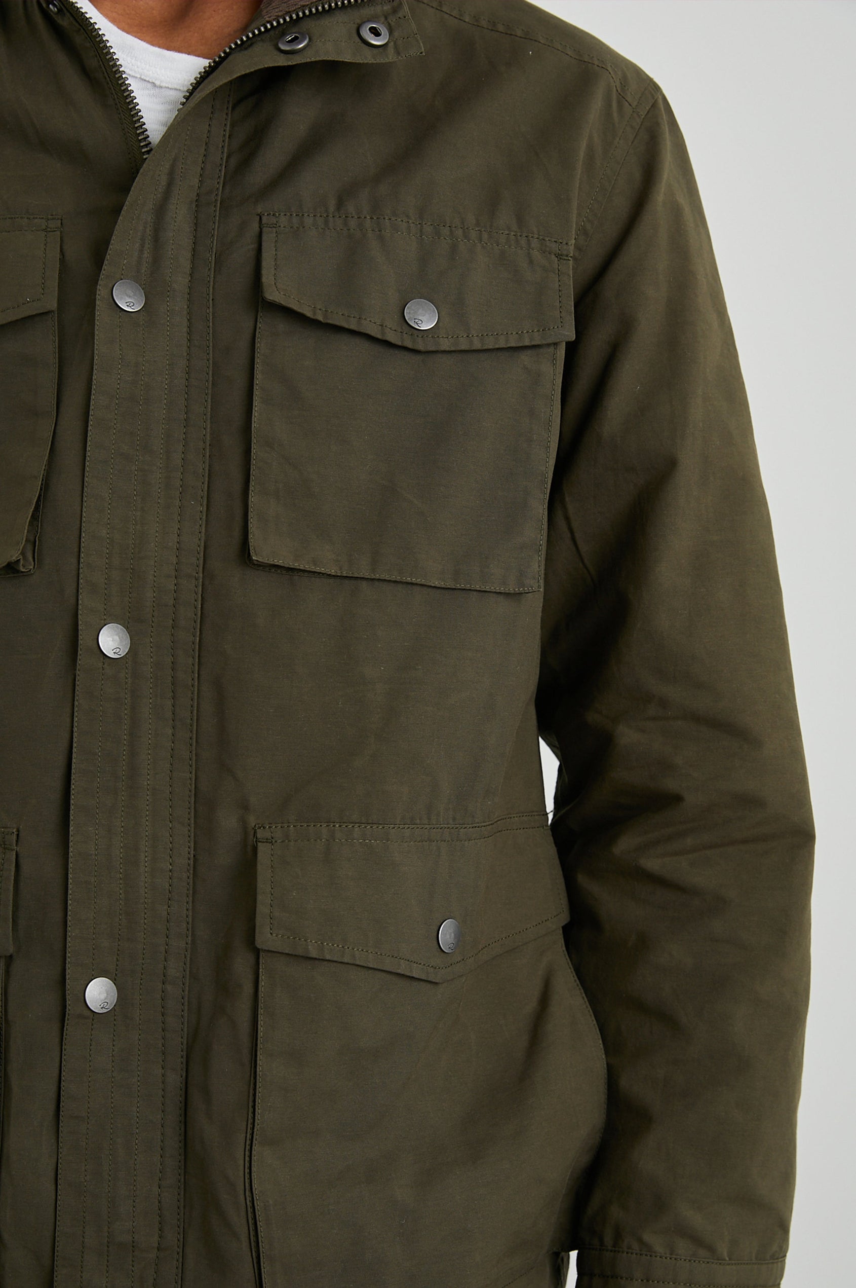 Cardiff Jacket with a Snap and Zipper Closure, Two Chest Snap Flap Pockets and Two Front Snap Flap Pockets in Dark Olive Colorway, with an Interior of Multicolor Horizontal Stripes - Front View Featured on Model  
